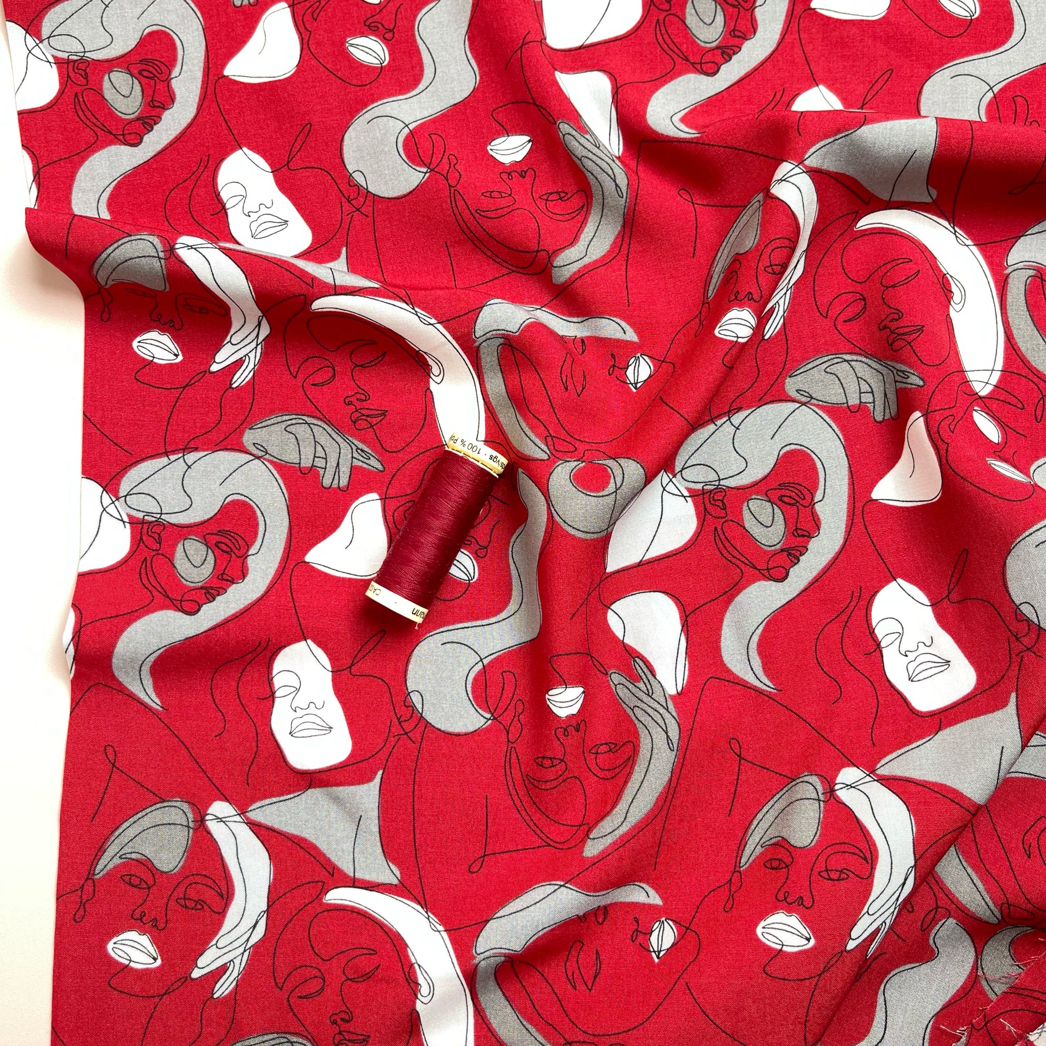 Faces on Red Viscose Fabric