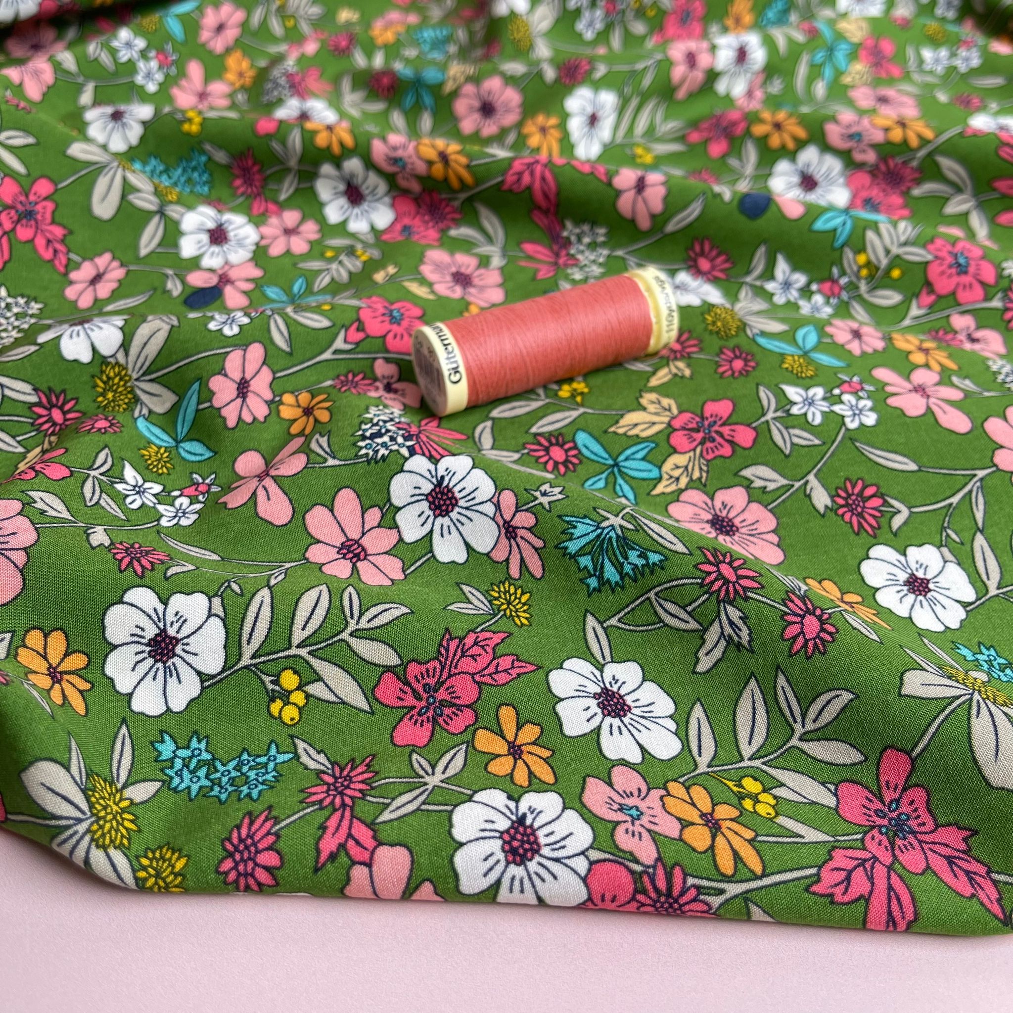 Spring Blossoms on Green Viscose Fabric