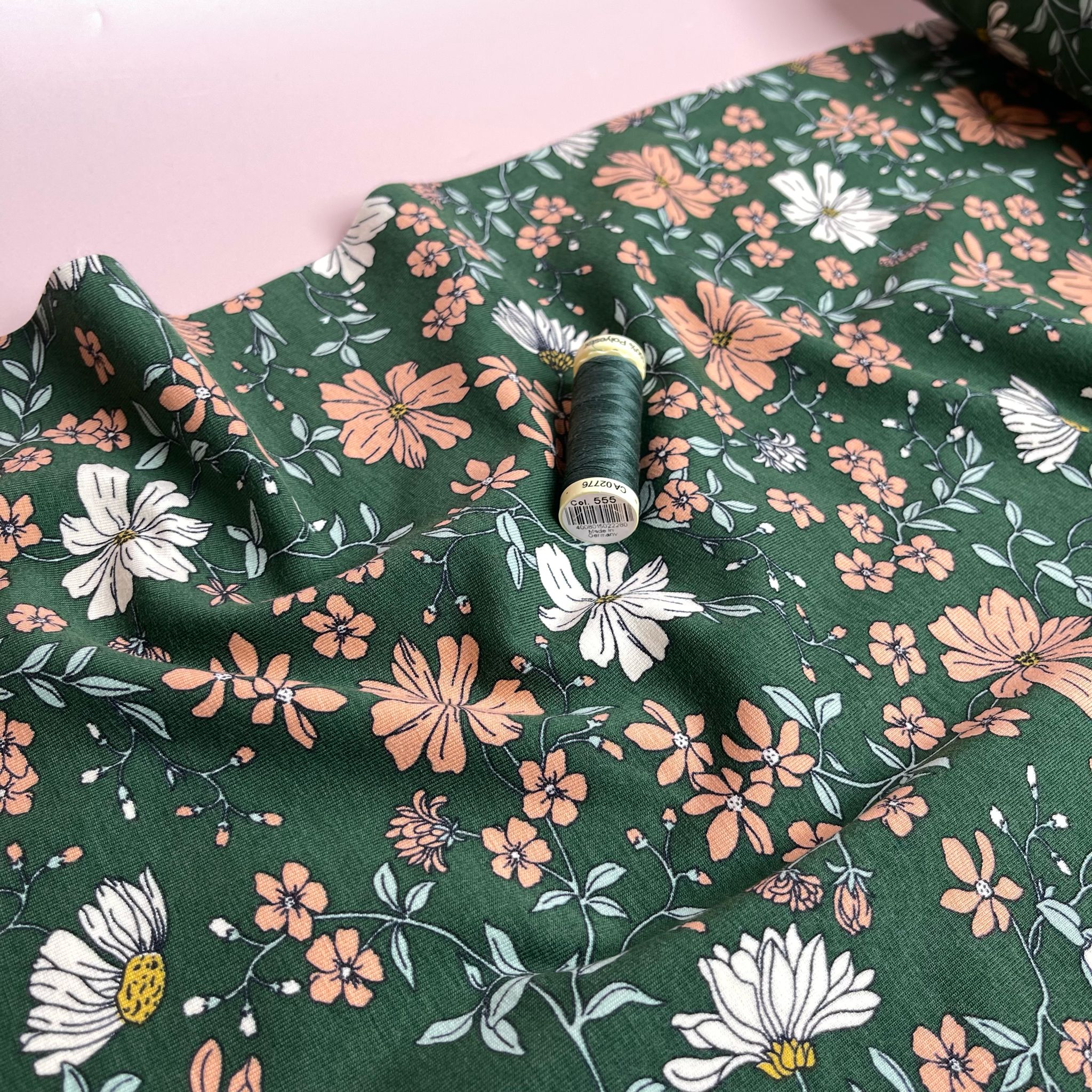Peach Flowers on Green Cotton Jersey Fabric