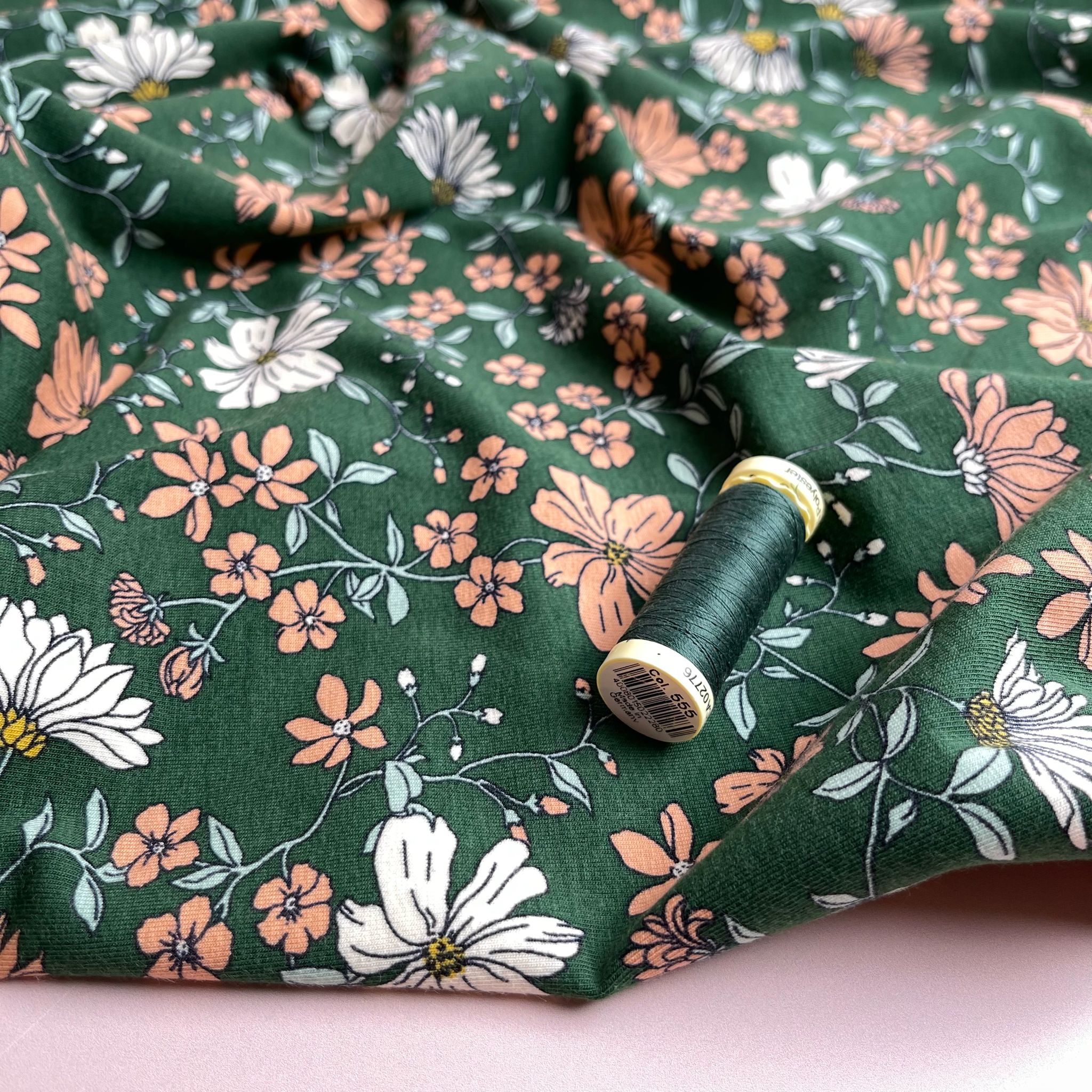 Peach Flowers on Green Cotton Jersey Fabric