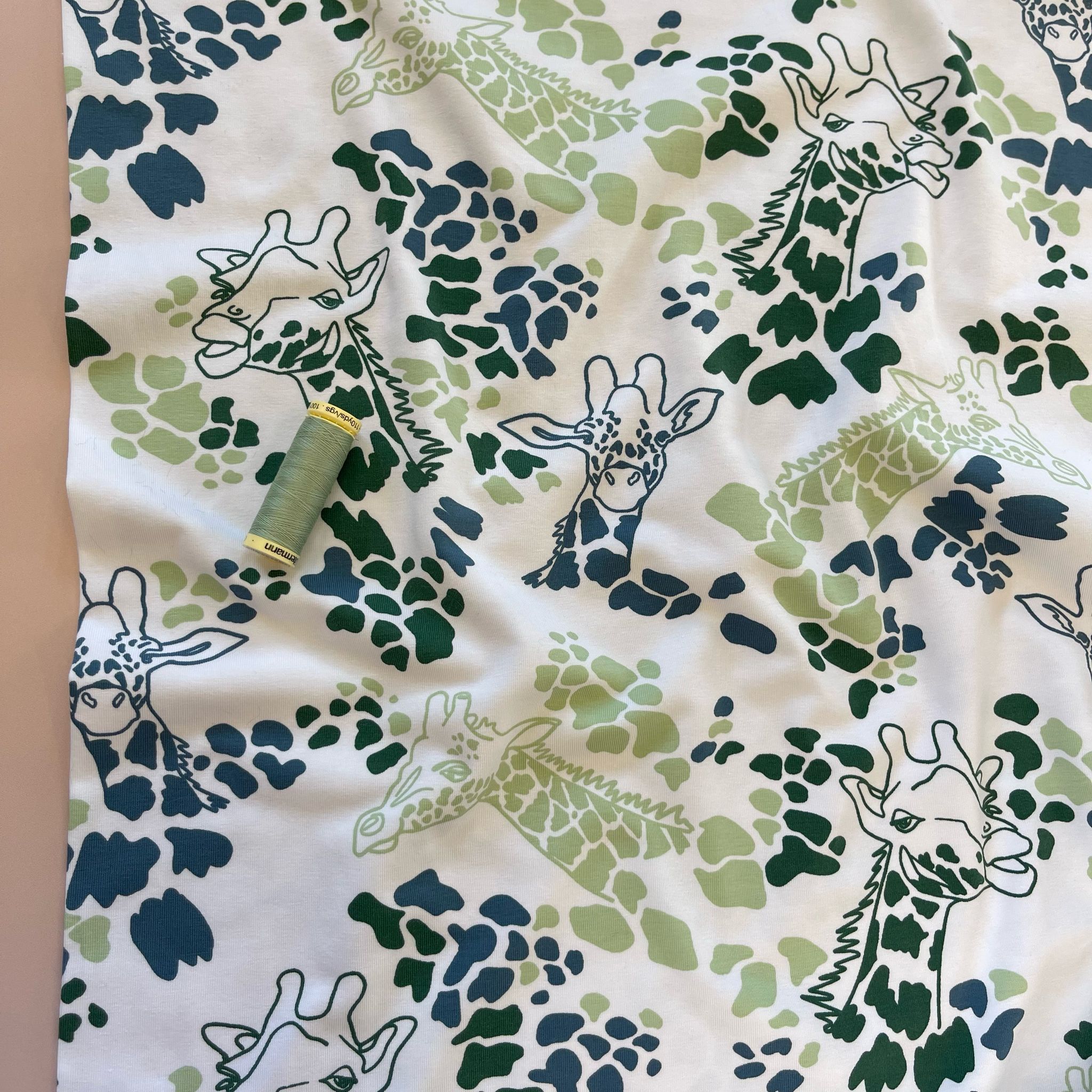 Giraffe's in Green Cotton Jersey Fabric