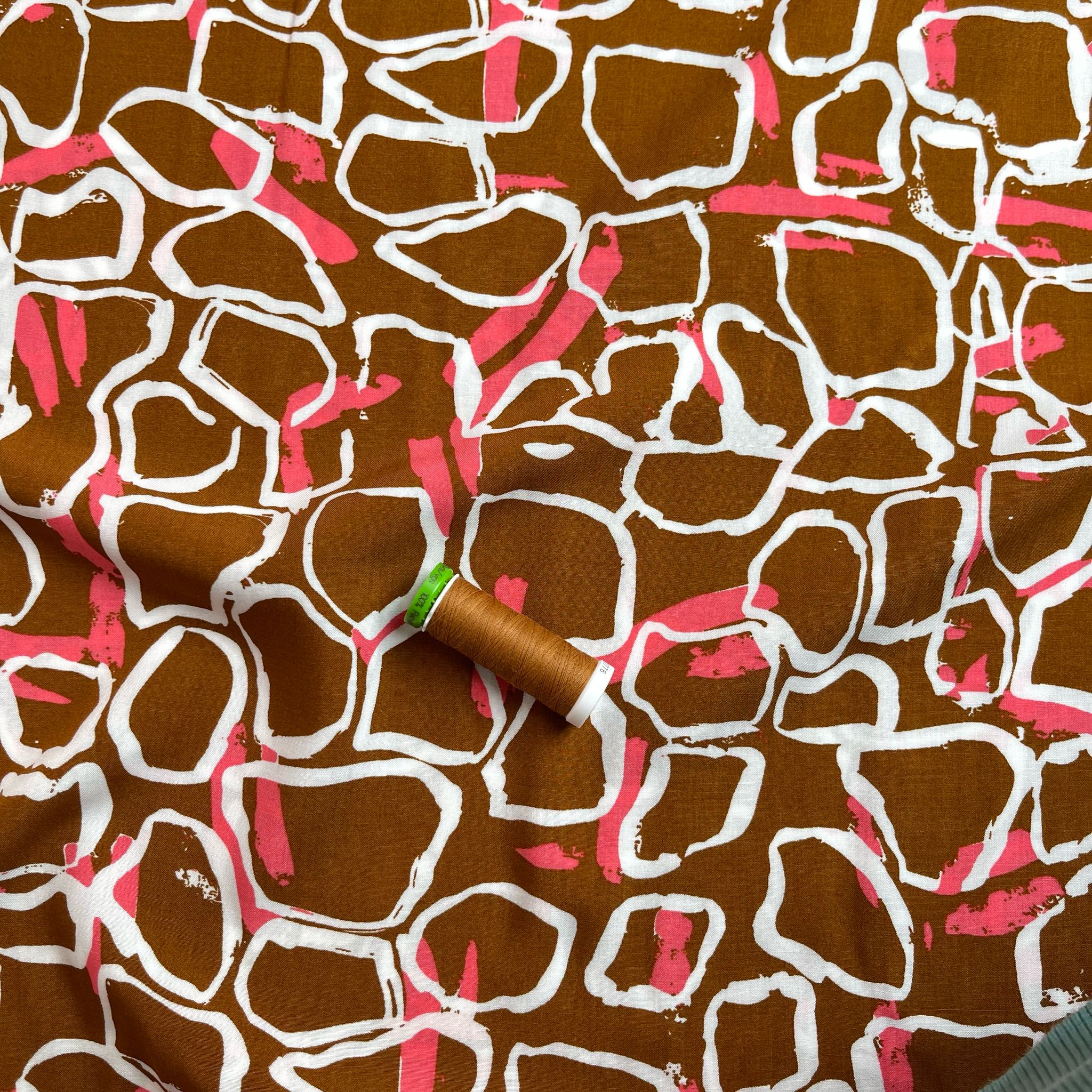 White Shapes on Brown Viscose Fabric