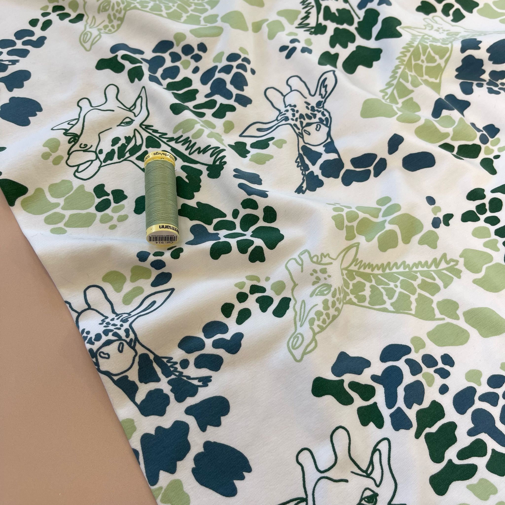 Giraffe's in Green Cotton Jersey Fabric