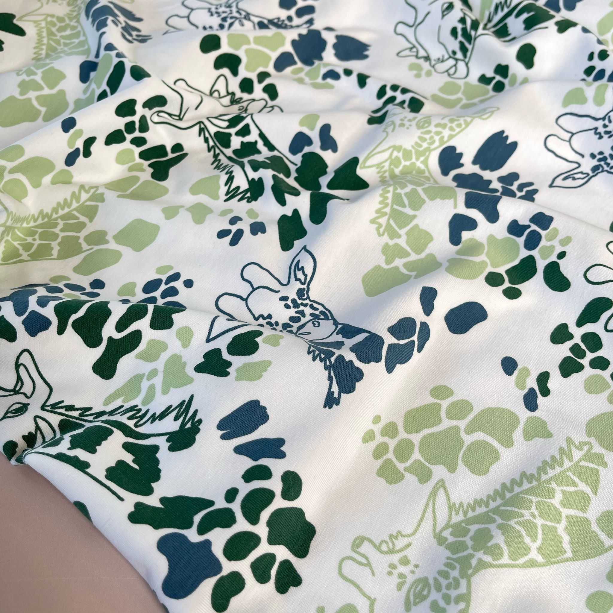 Giraffe's in Green Cotton Jersey Fabric