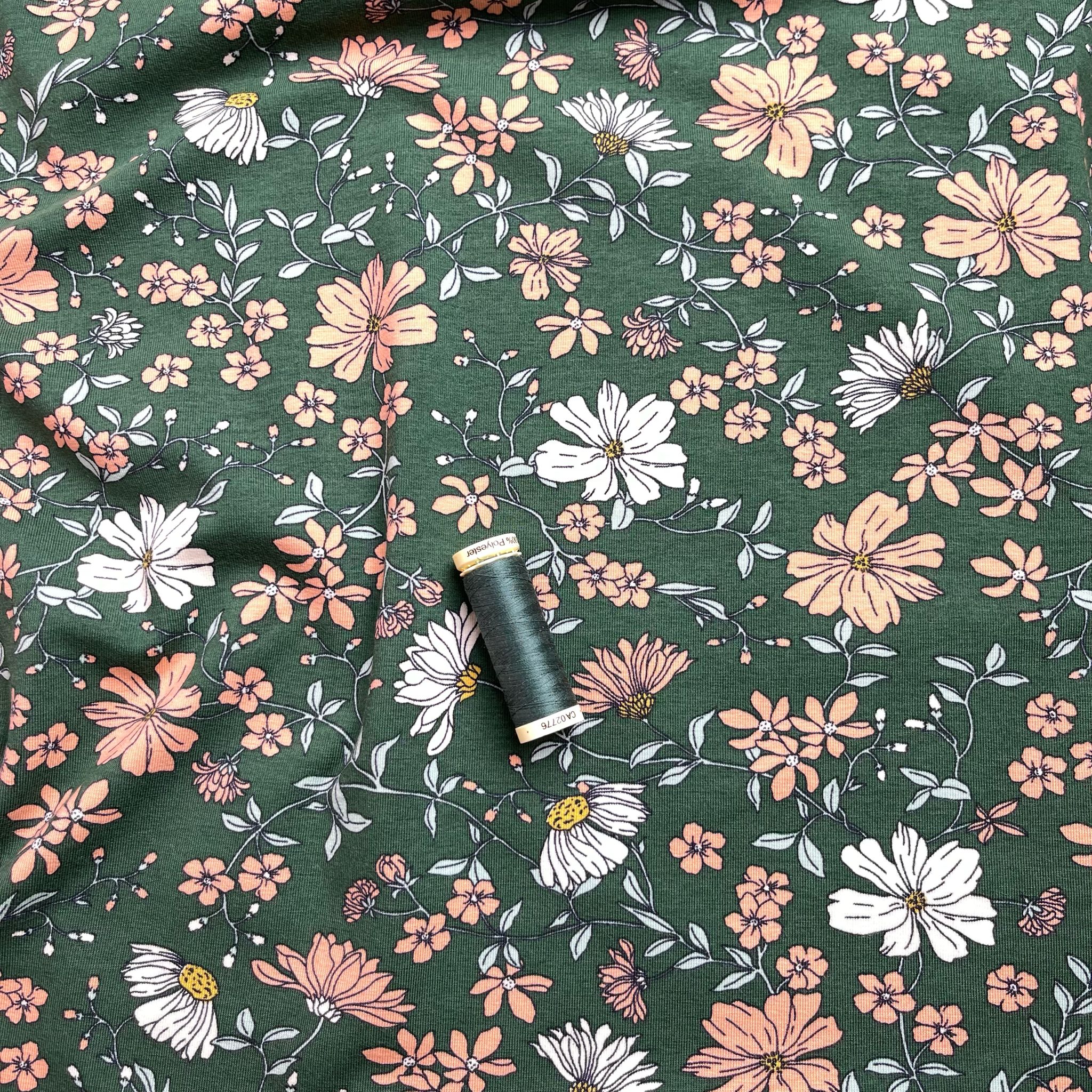 Peach Flowers on Green Cotton Jersey Fabric
