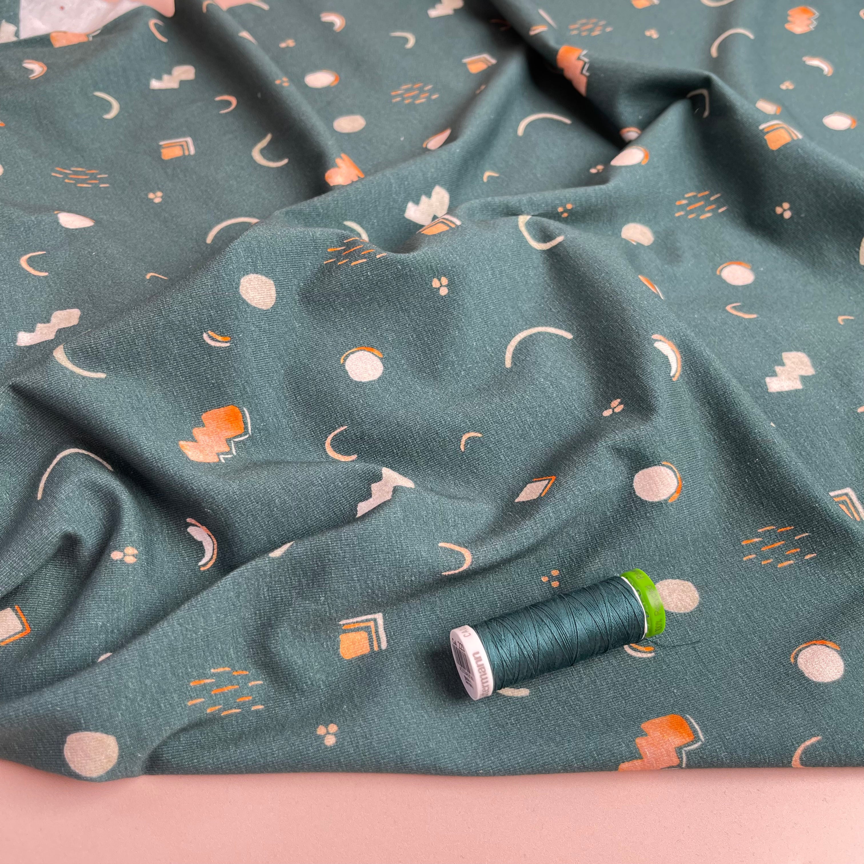 Graphic Shapes on Green Cotton Jersey Fabric