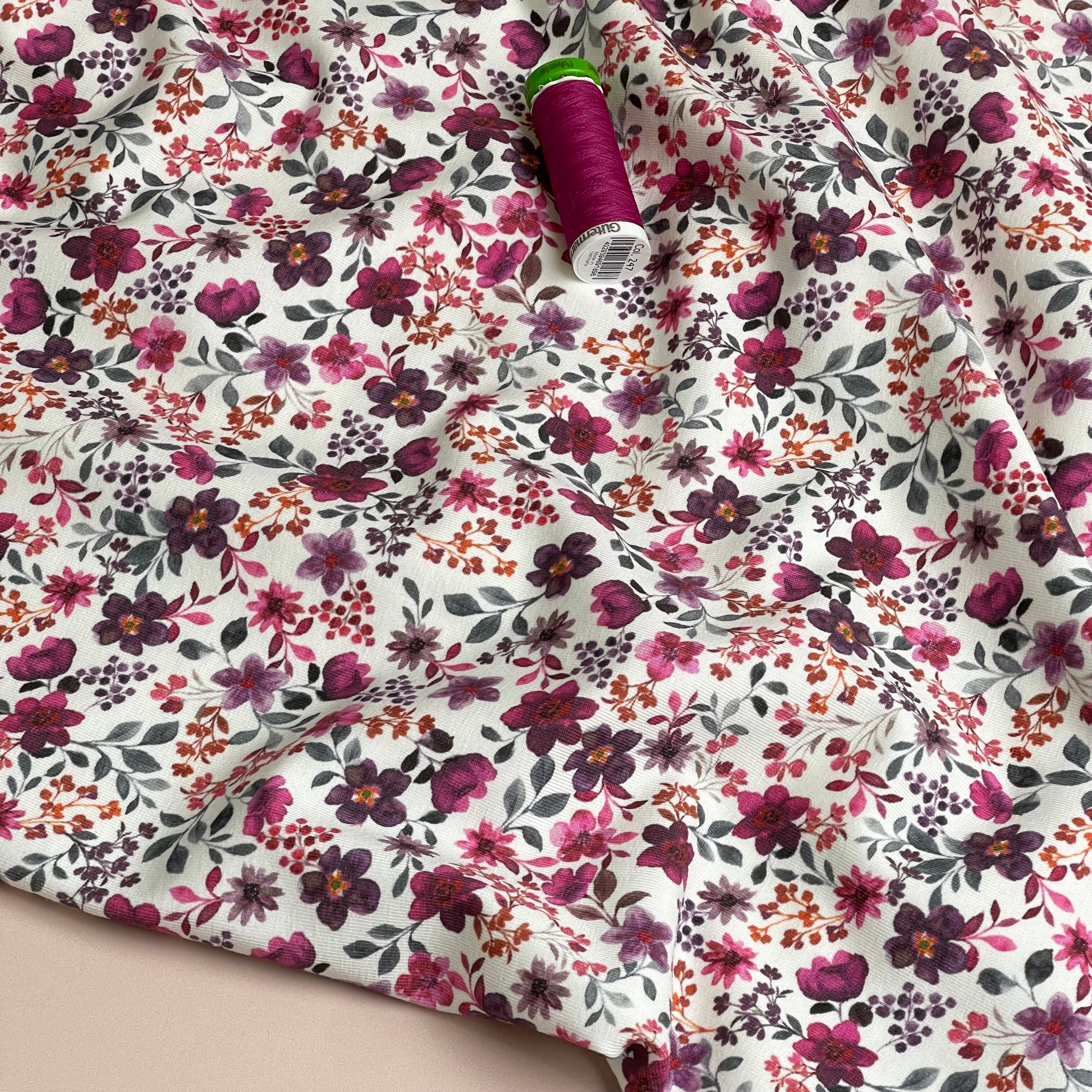 Ditsy Plum Flowers on White Cotton Jersey Fabric