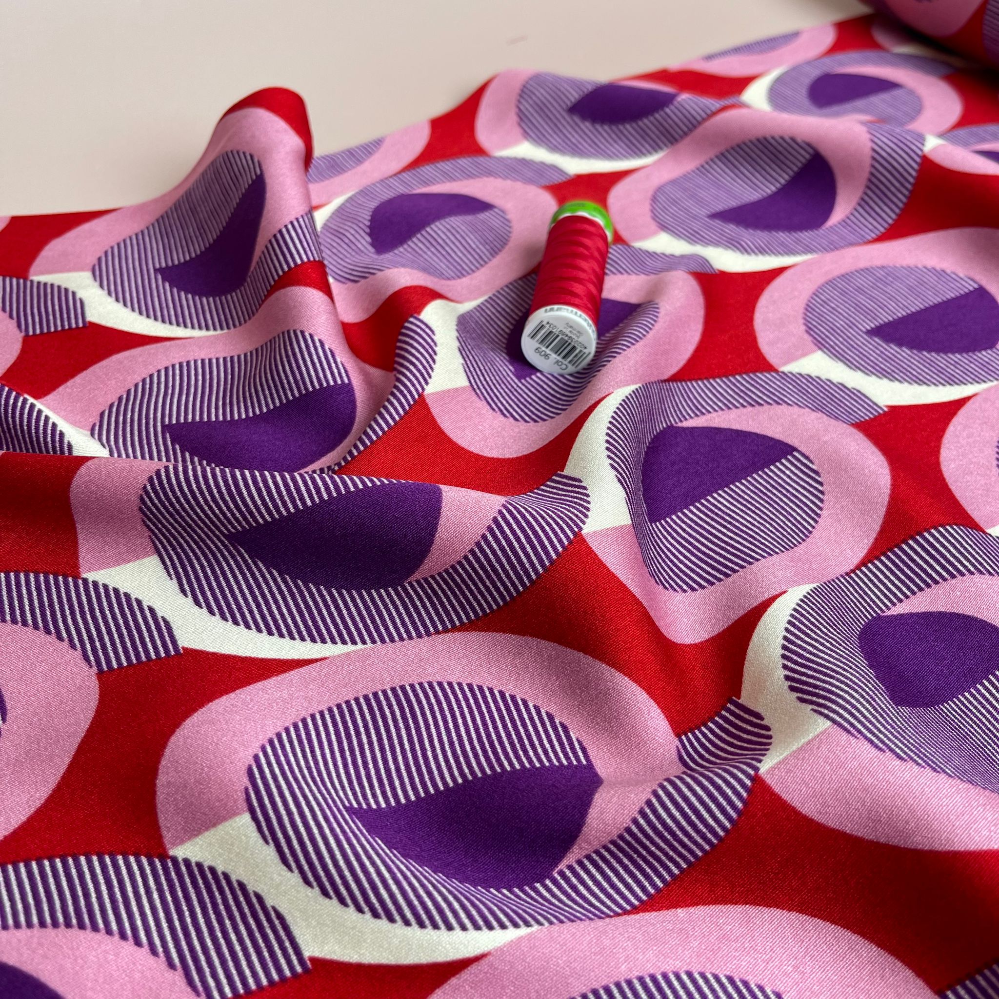 REMNANT 0.55 Metre - Abstract Circles on Red Viscose Twill Sateen Fabric