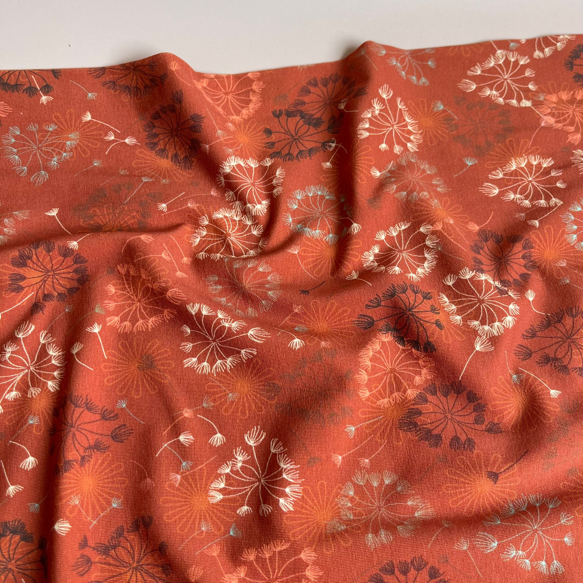 Danish Design - Dandelion on Rust Cotton Jersey Fabric