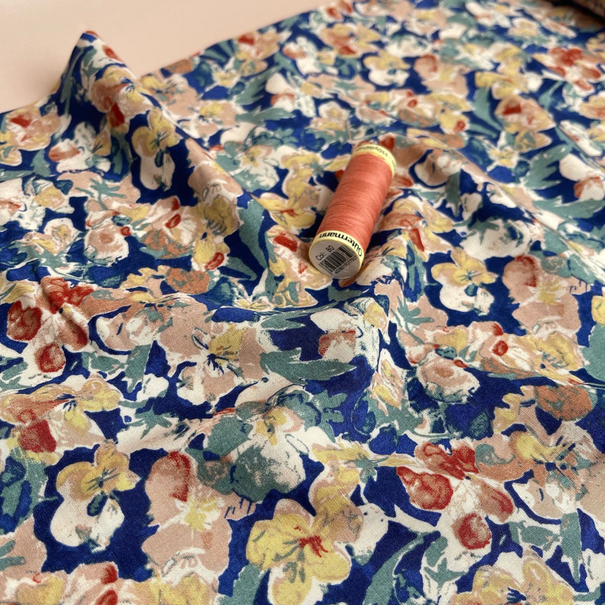 Soft Autumn Blossoms on Blue Viscose Fabric