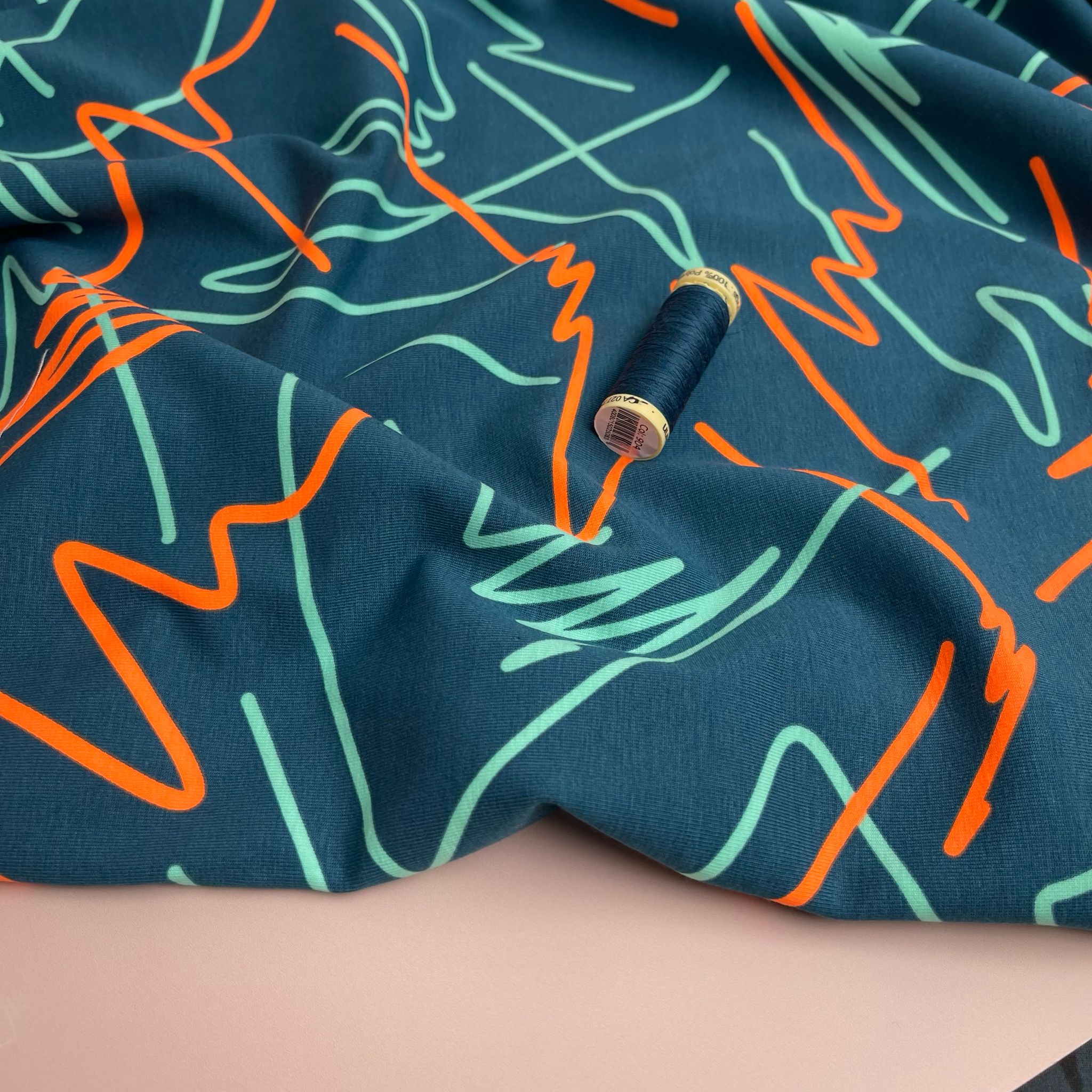 Neon Doodles on Dark Teal Cotton Jersey Fabric