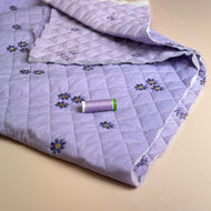 Embroidered Flowers on Lilac Quilted Fabric