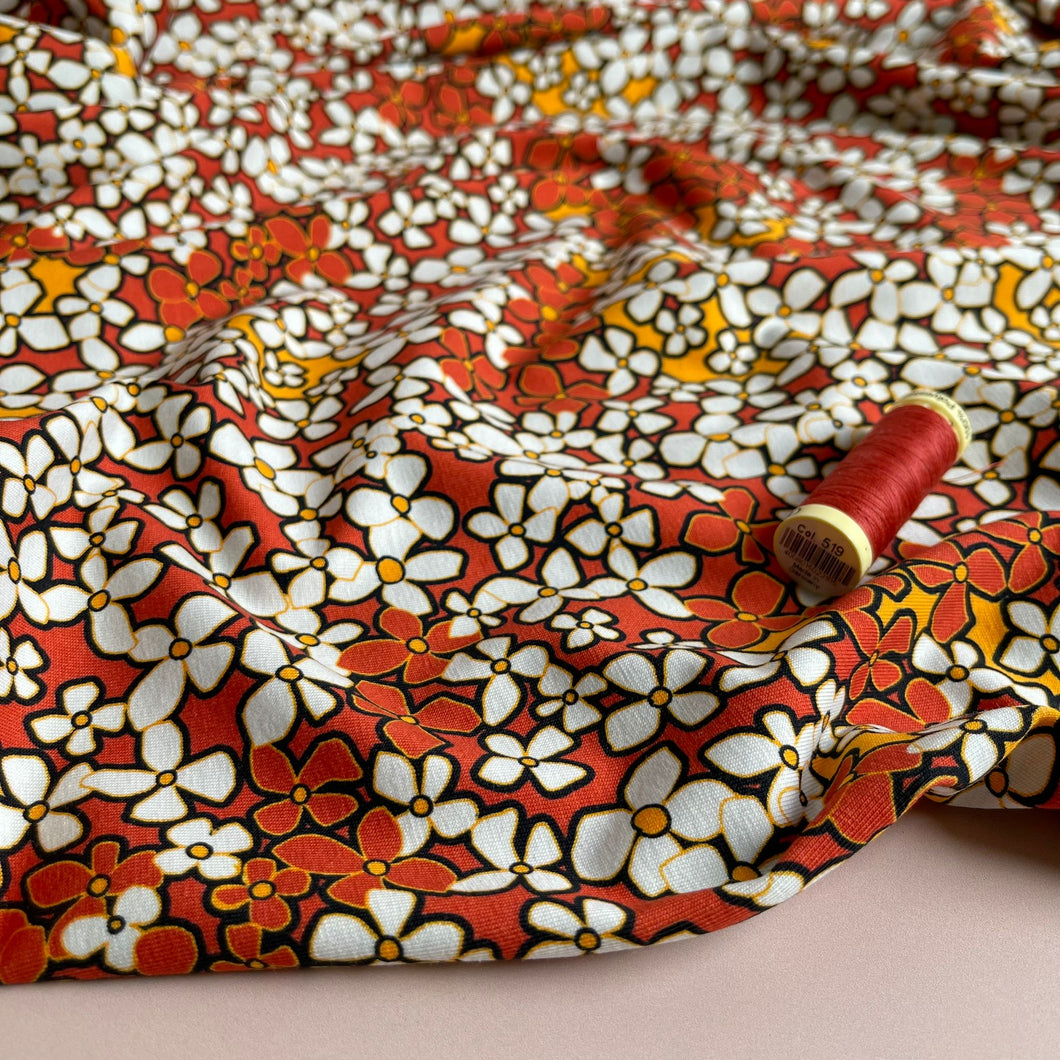 Danish Design - Small Retro Flowers on Burnt Orange Cotton Jersey Fabric