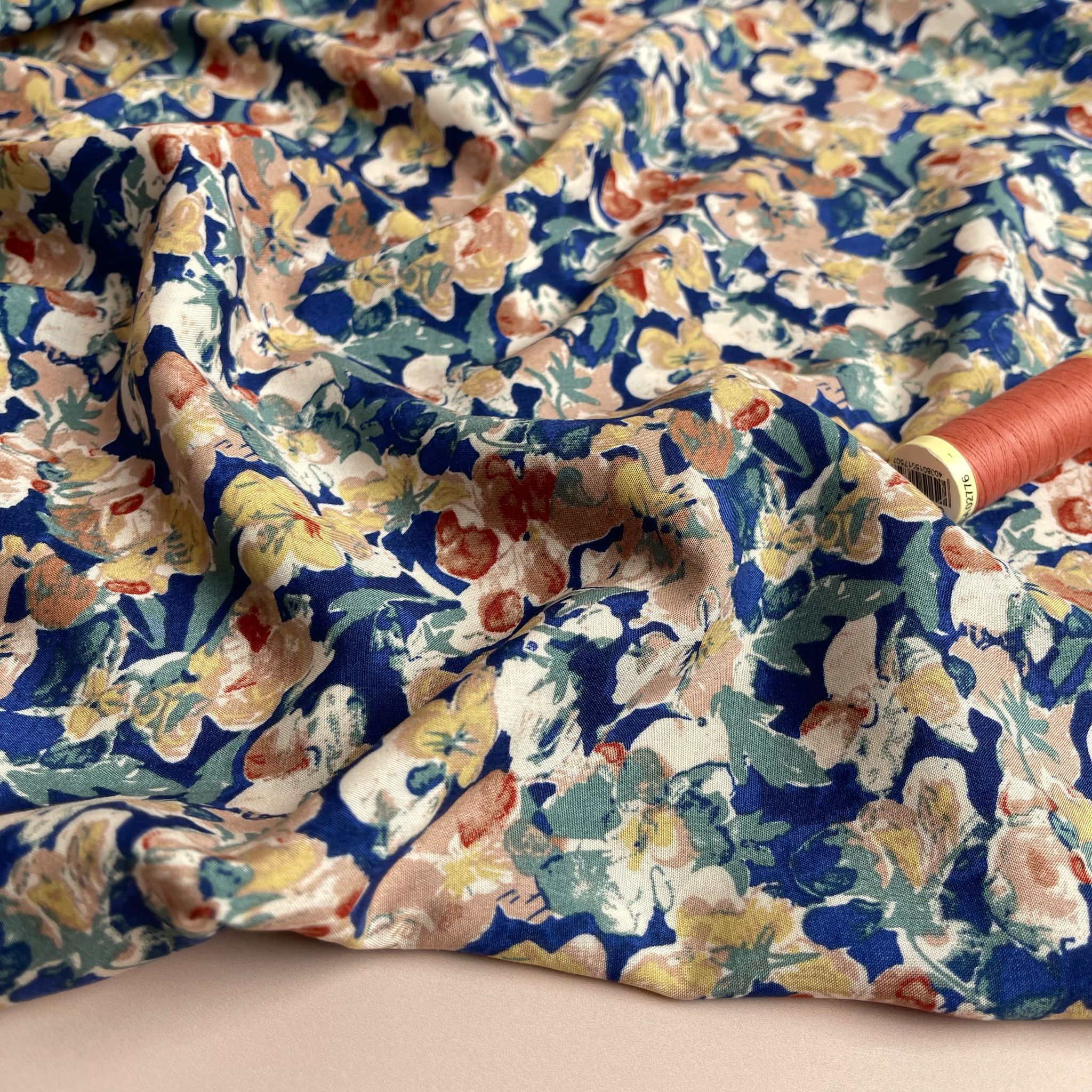 Soft Autumn Blossoms on Blue Viscose Fabric