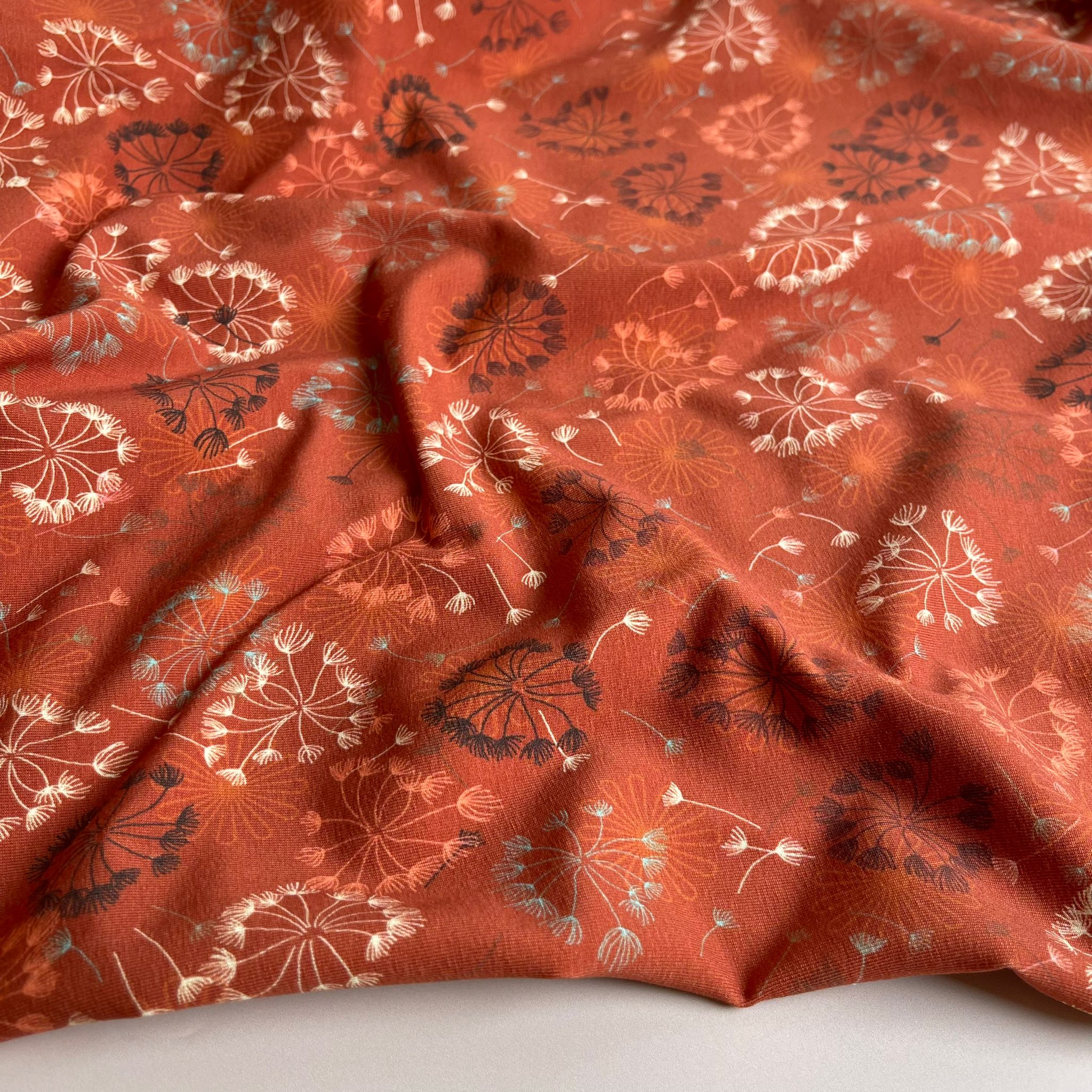 Danish Design - Dandelion on Rust Cotton Jersey Fabric