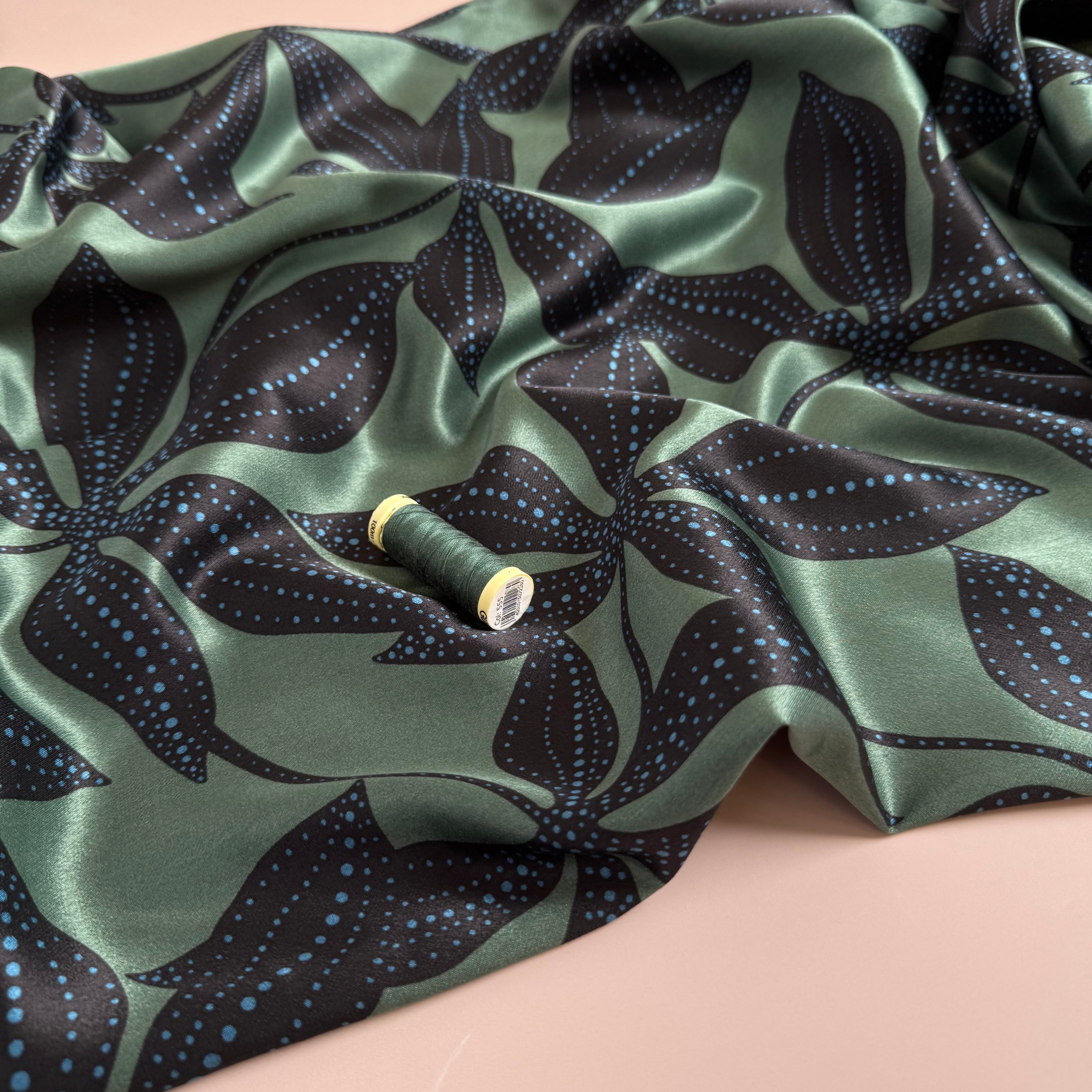 Spotty Flowers on Green Spun Viscose Sateen Fabric