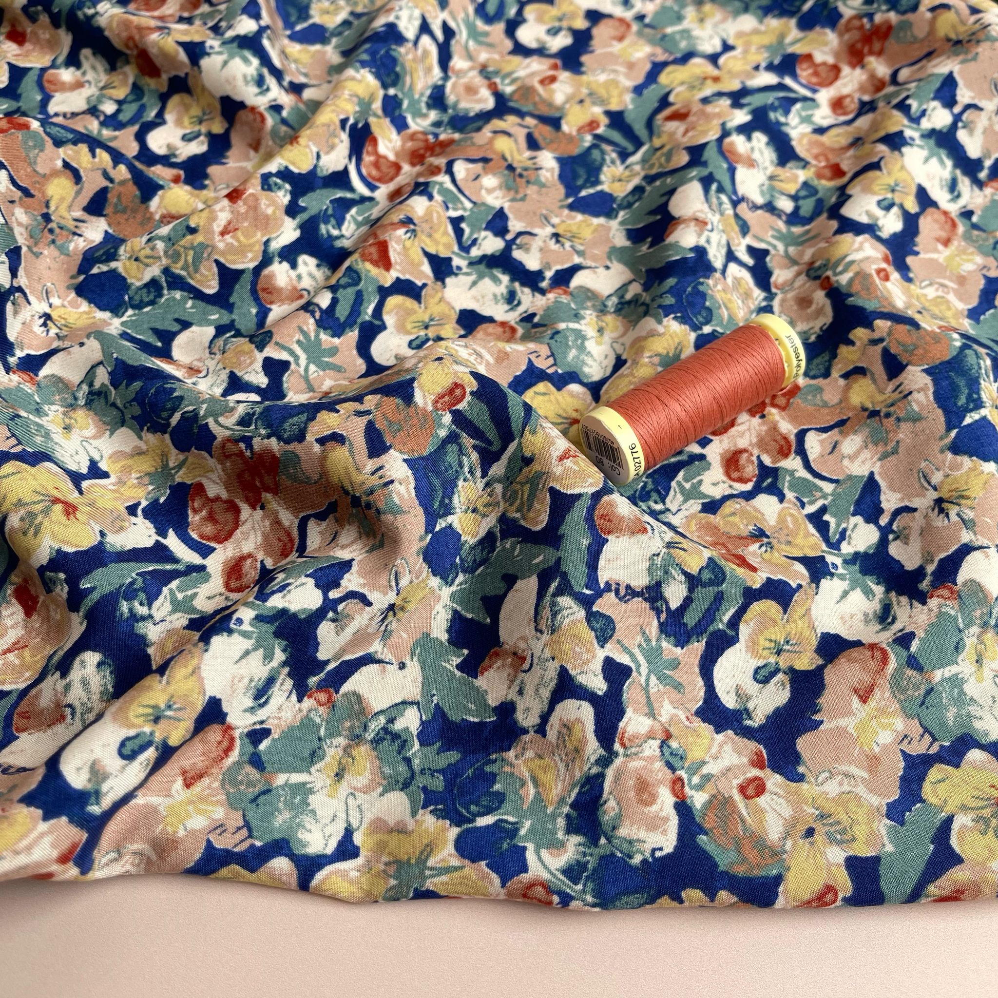 Soft Autumn Blossoms on Blue Viscose Fabric