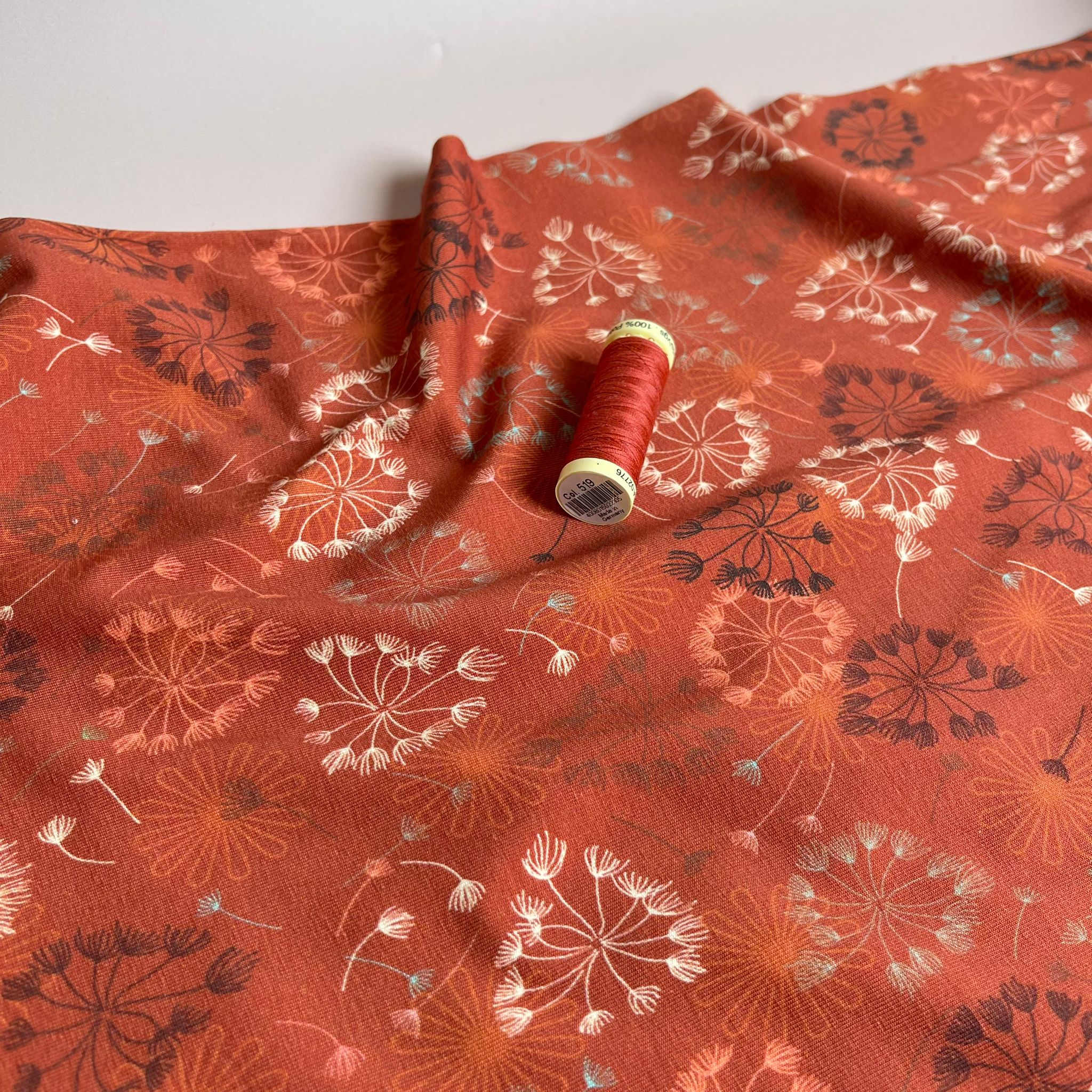 Danish Design - Dandelion on Rust Cotton Jersey Fabric