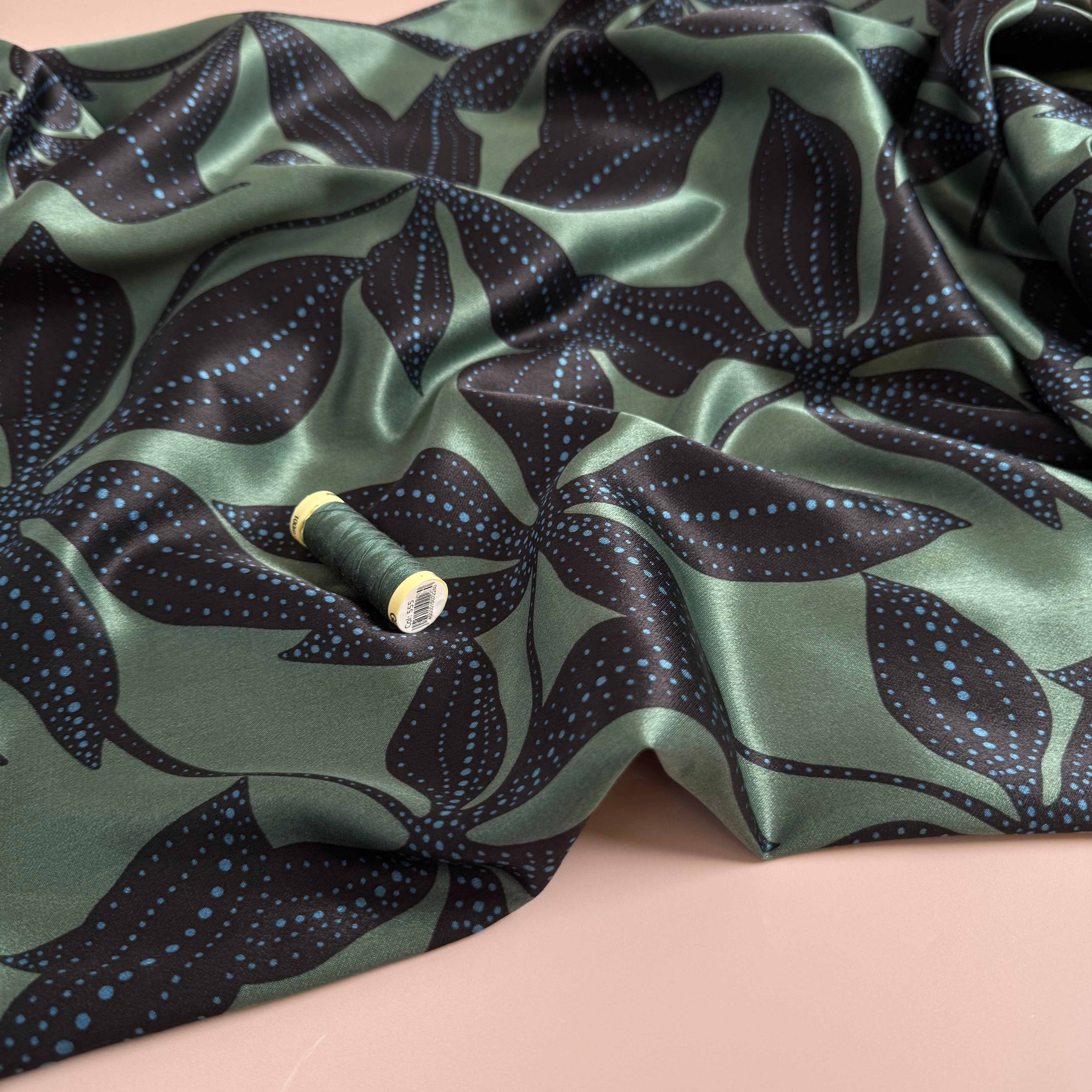 Spotty Flowers on Green Spun Viscose Sateen Fabric