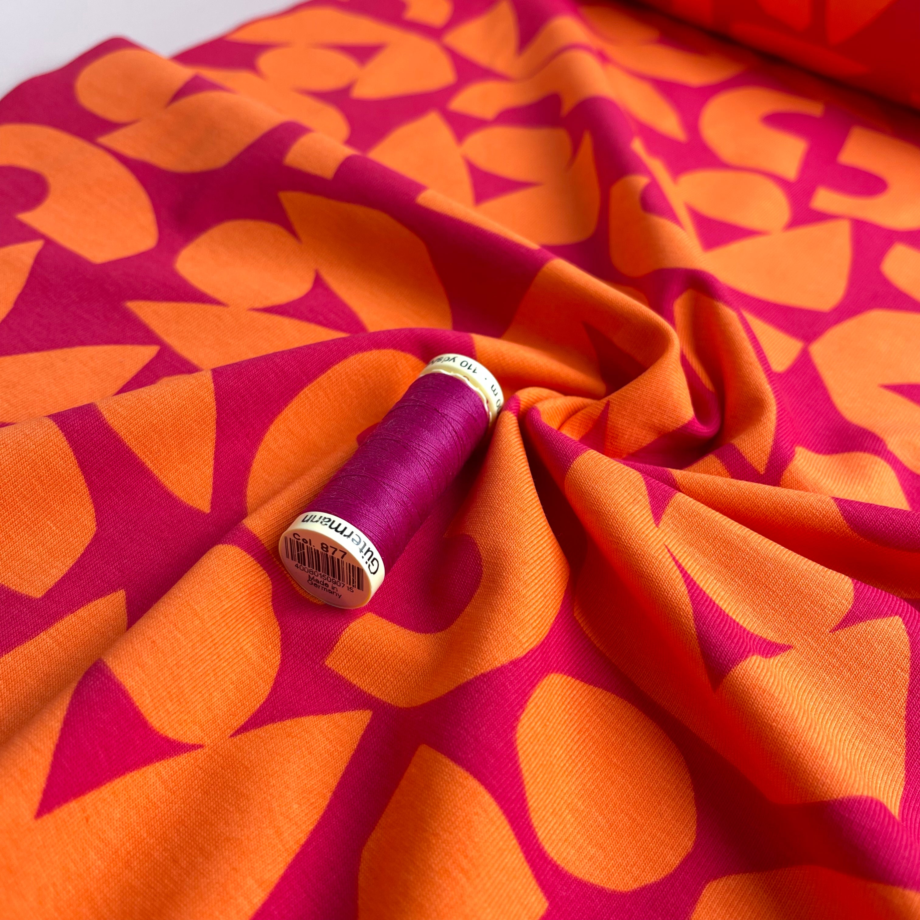 Orange Shapes on Cerise Combed Cotton Jersey Fabric