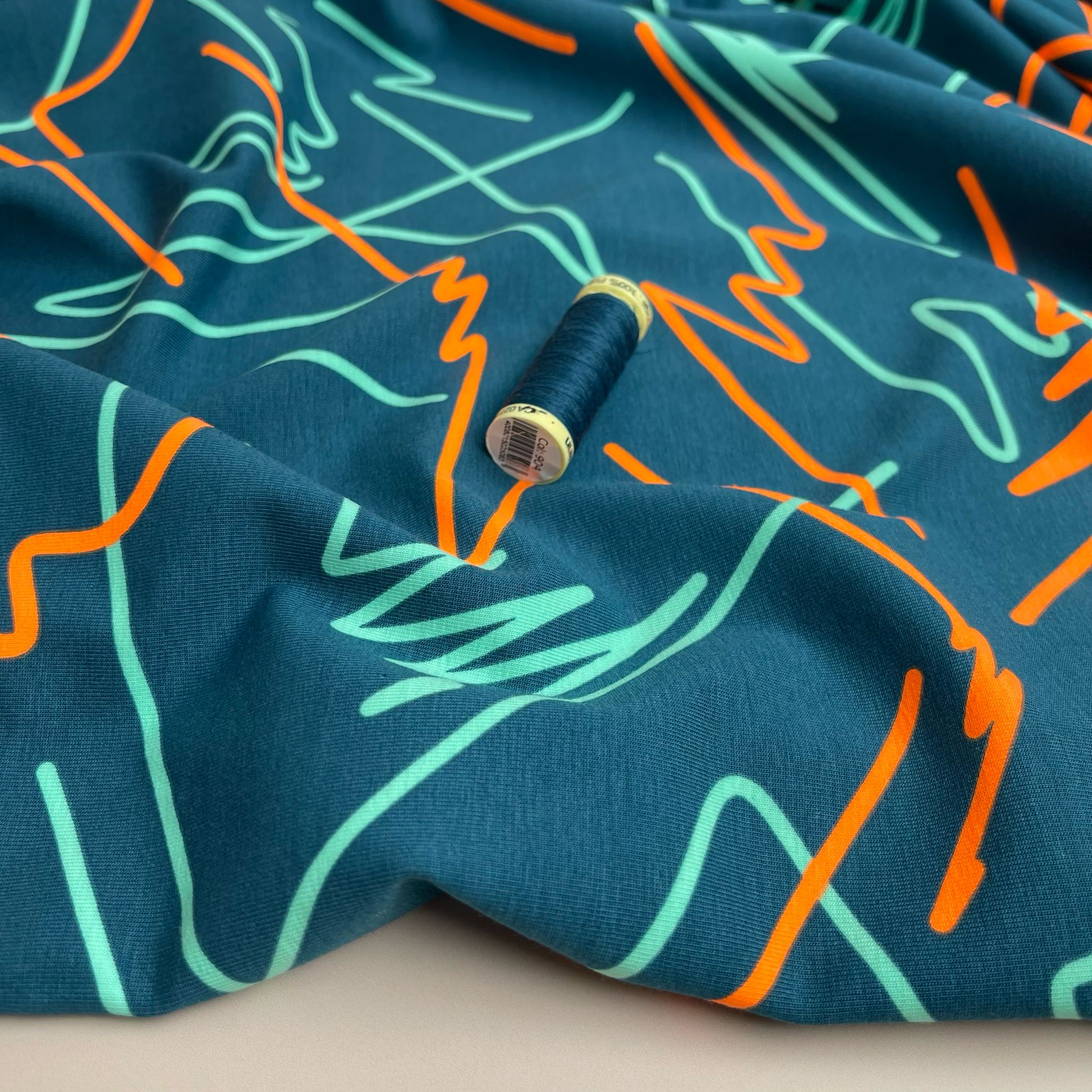 Neon Doodles on Dark Teal Cotton Jersey Fabric