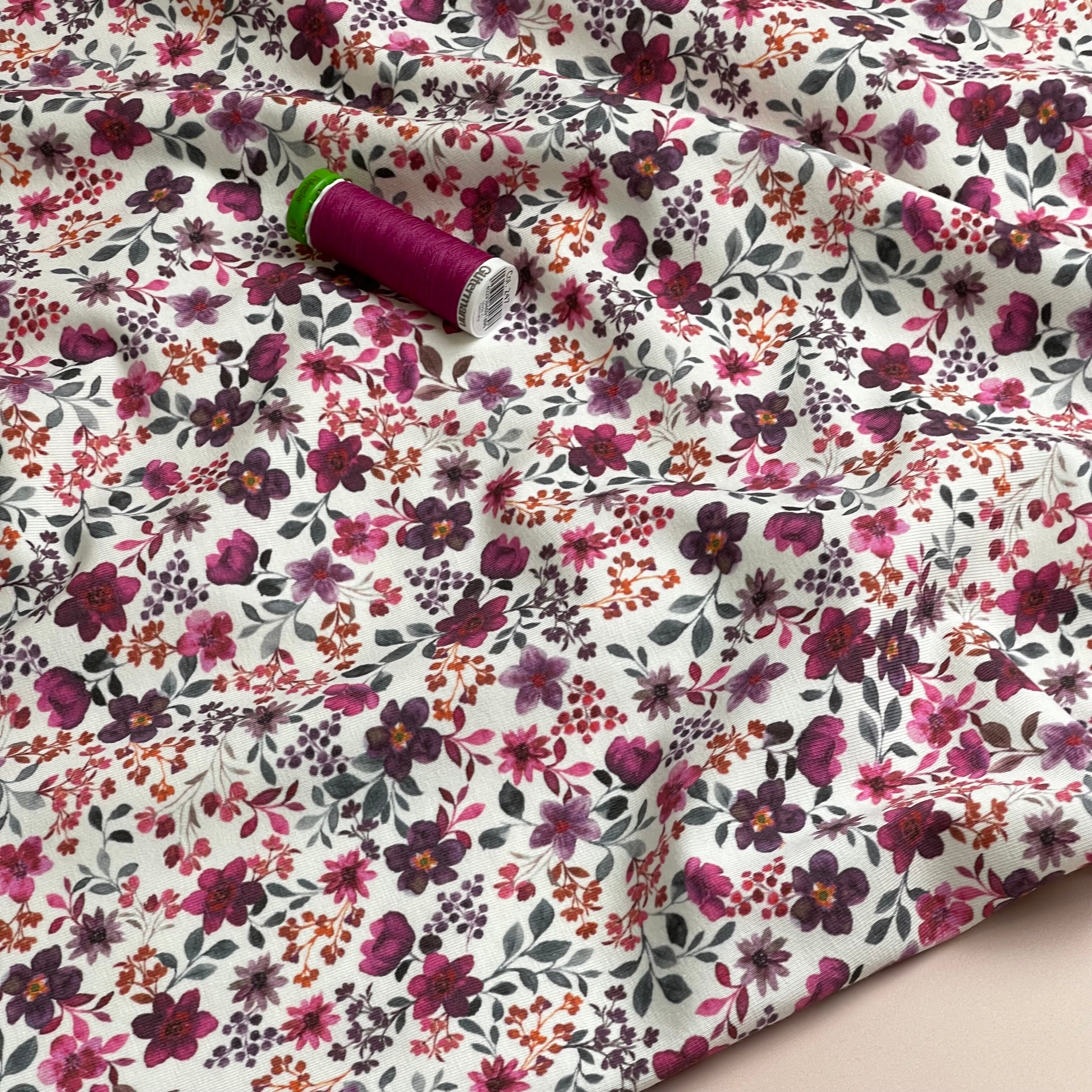 Ditsy Plum Flowers on White Cotton Jersey Fabric