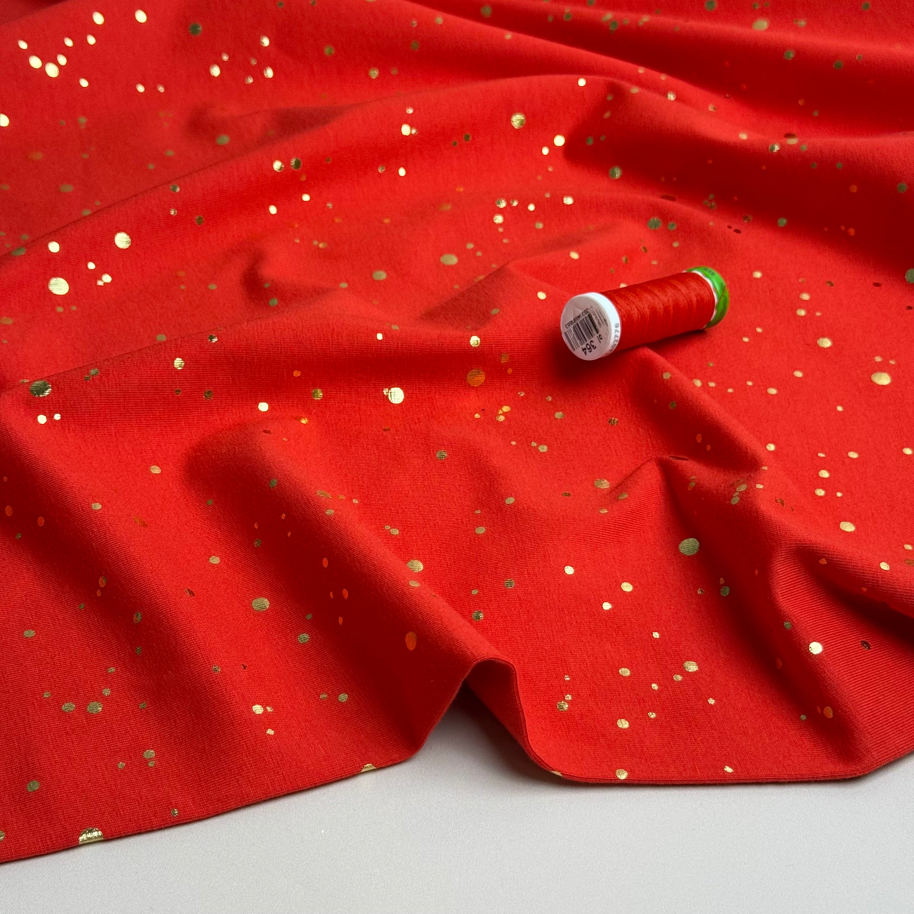 Gold Confetti on Bright Red Cotton Jersey Fabric