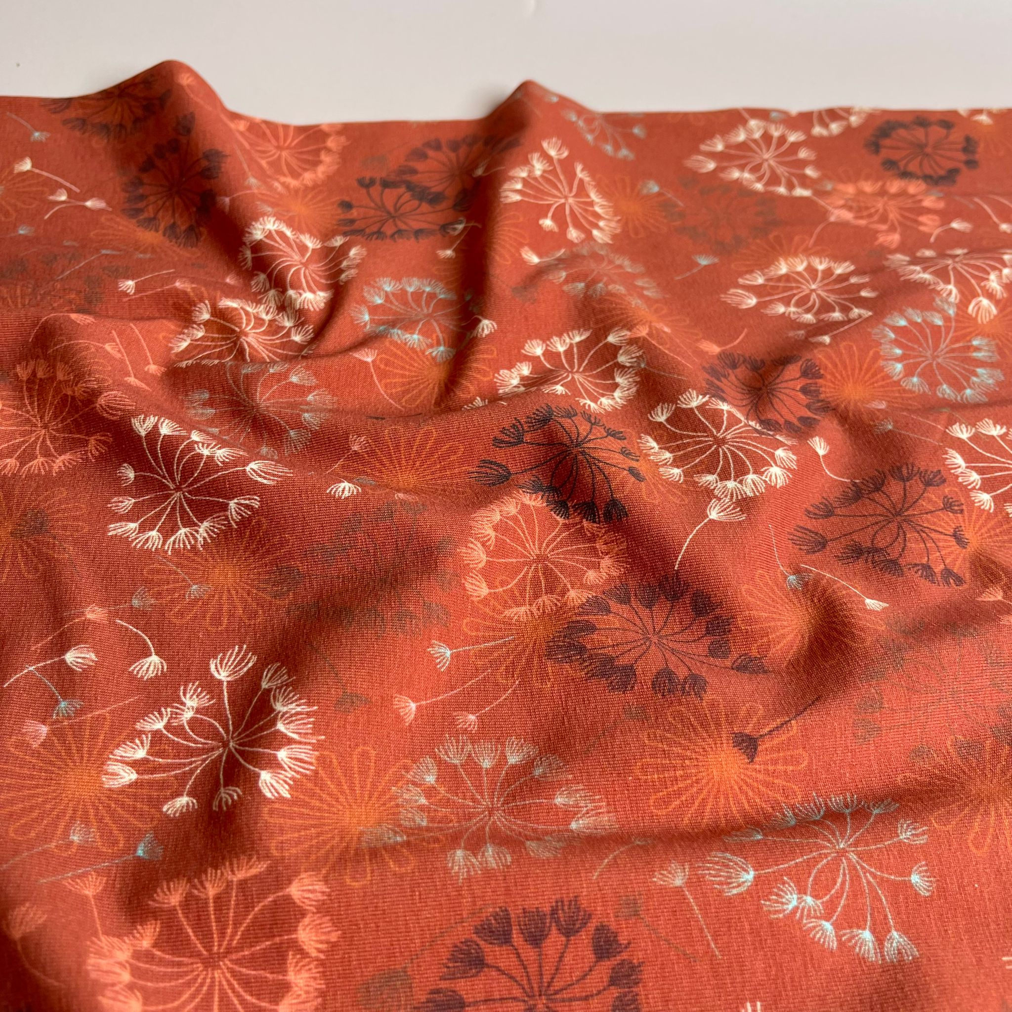 Danish Design - Dandelion on Rust Cotton Jersey Fabric