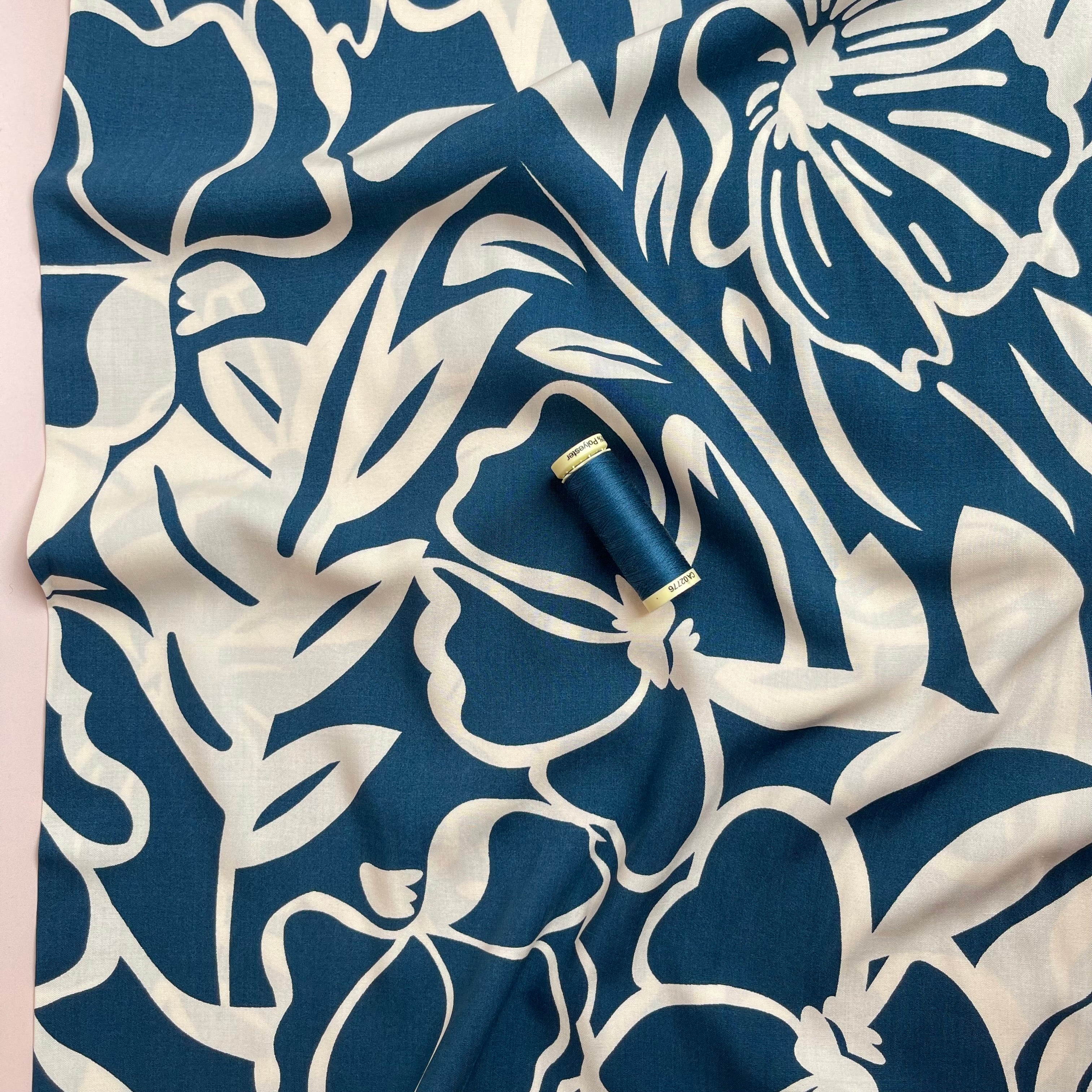 Off-White Blooms on Blue Viscose Fabric