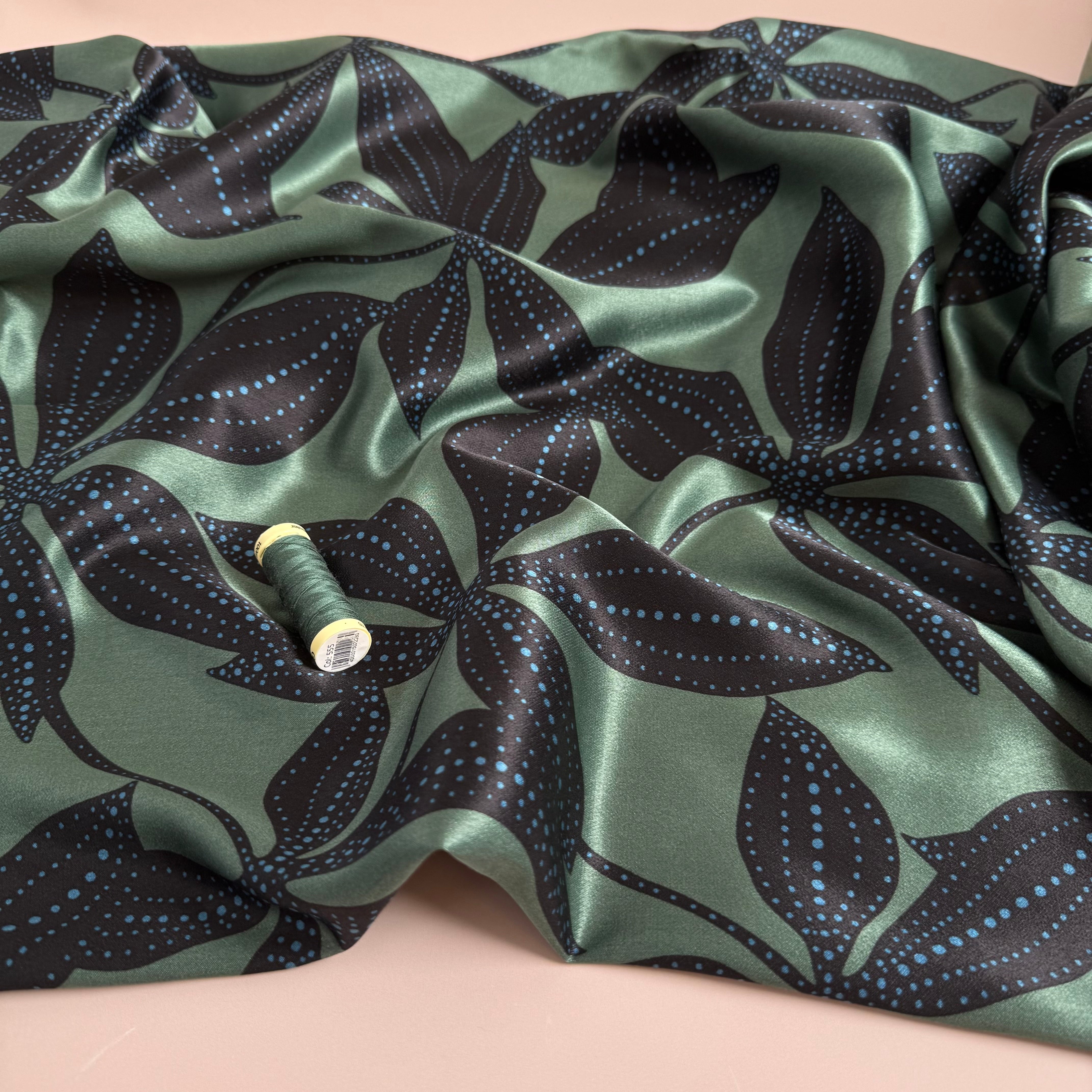 Spotty Flowers on Green Spun Viscose Sateen Fabric