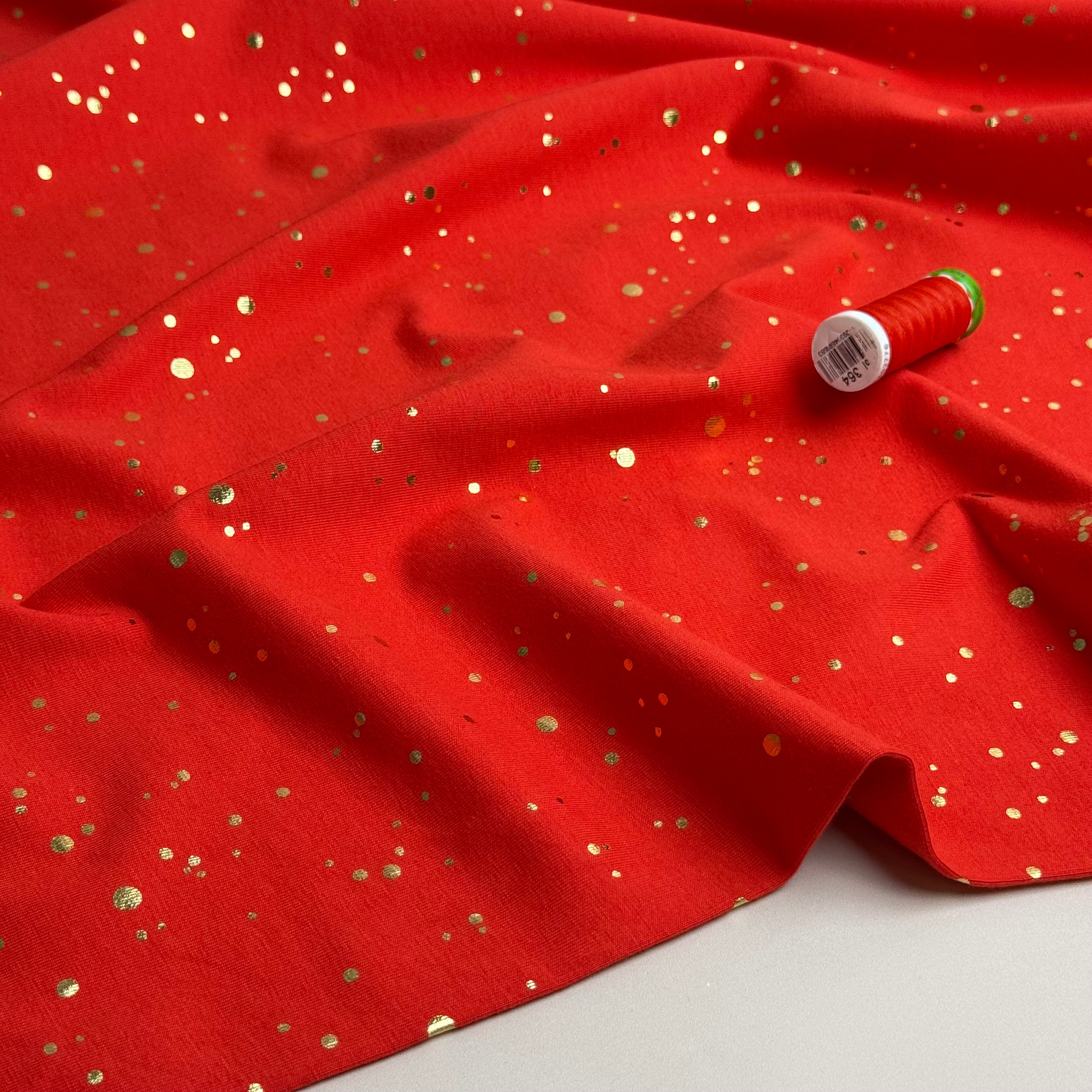 Gold Confetti on Bright Red Cotton Jersey Fabric