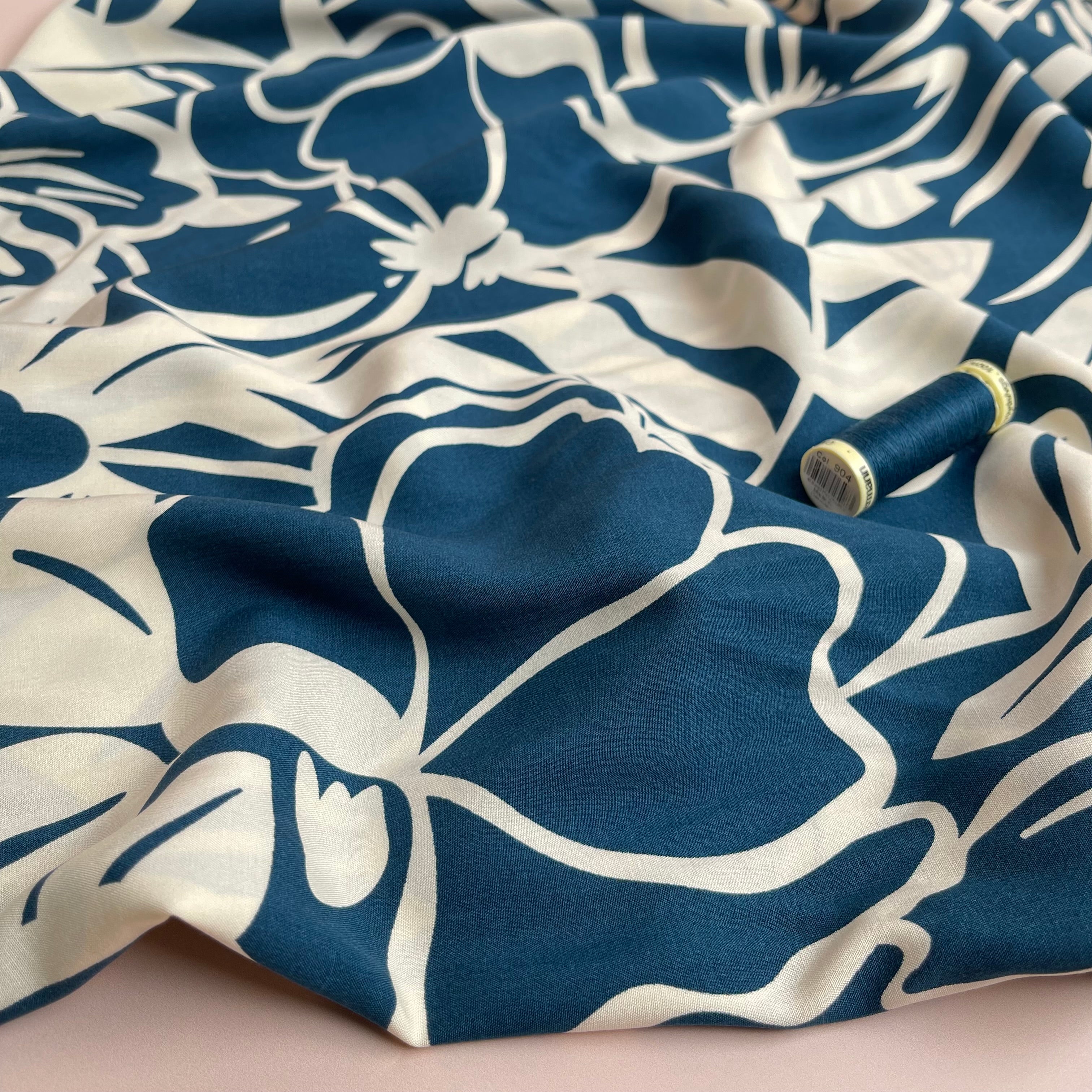 Off-White Blooms on Blue Viscose Fabric