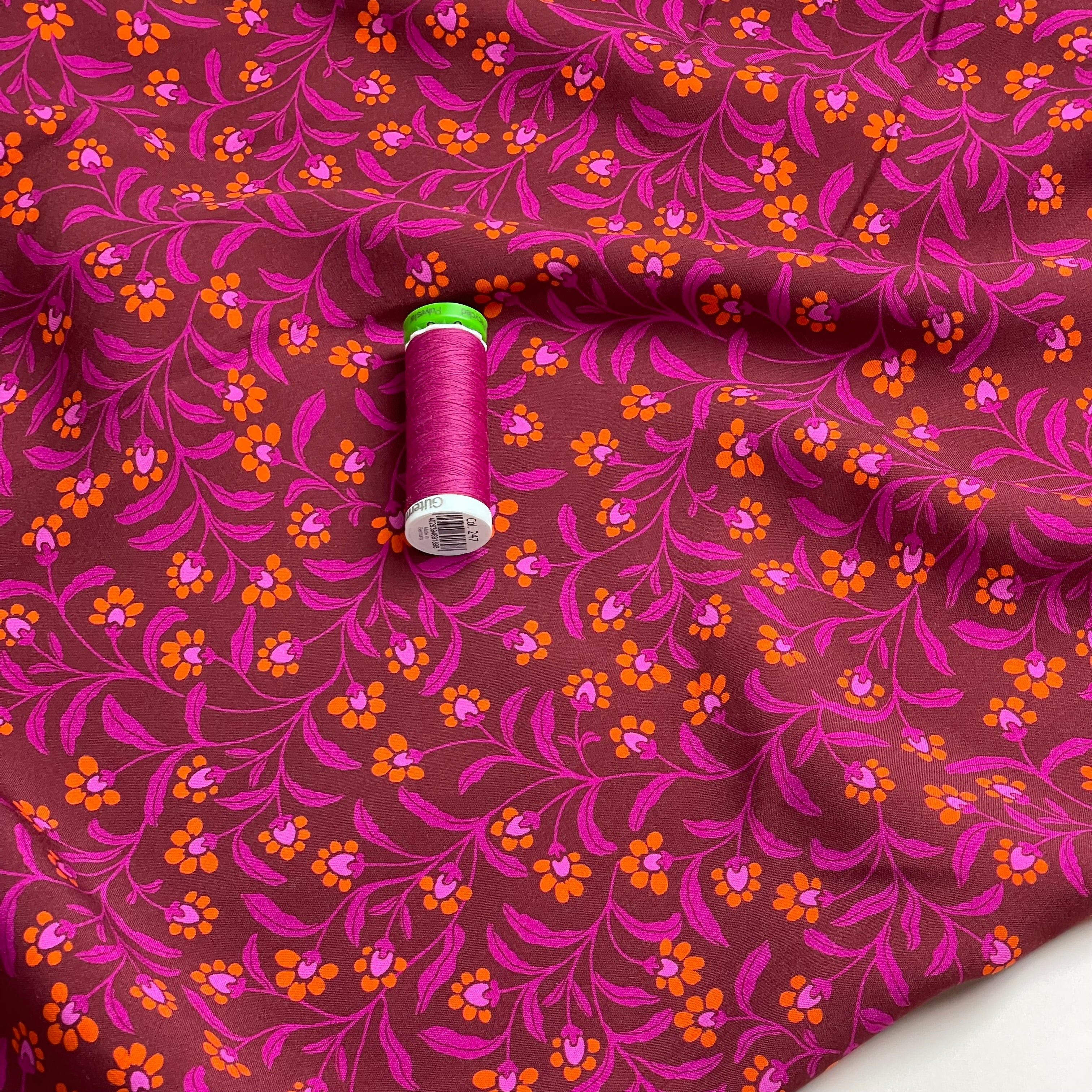 Ditsy Orange Flowers on Burgundy Viscose Fabric