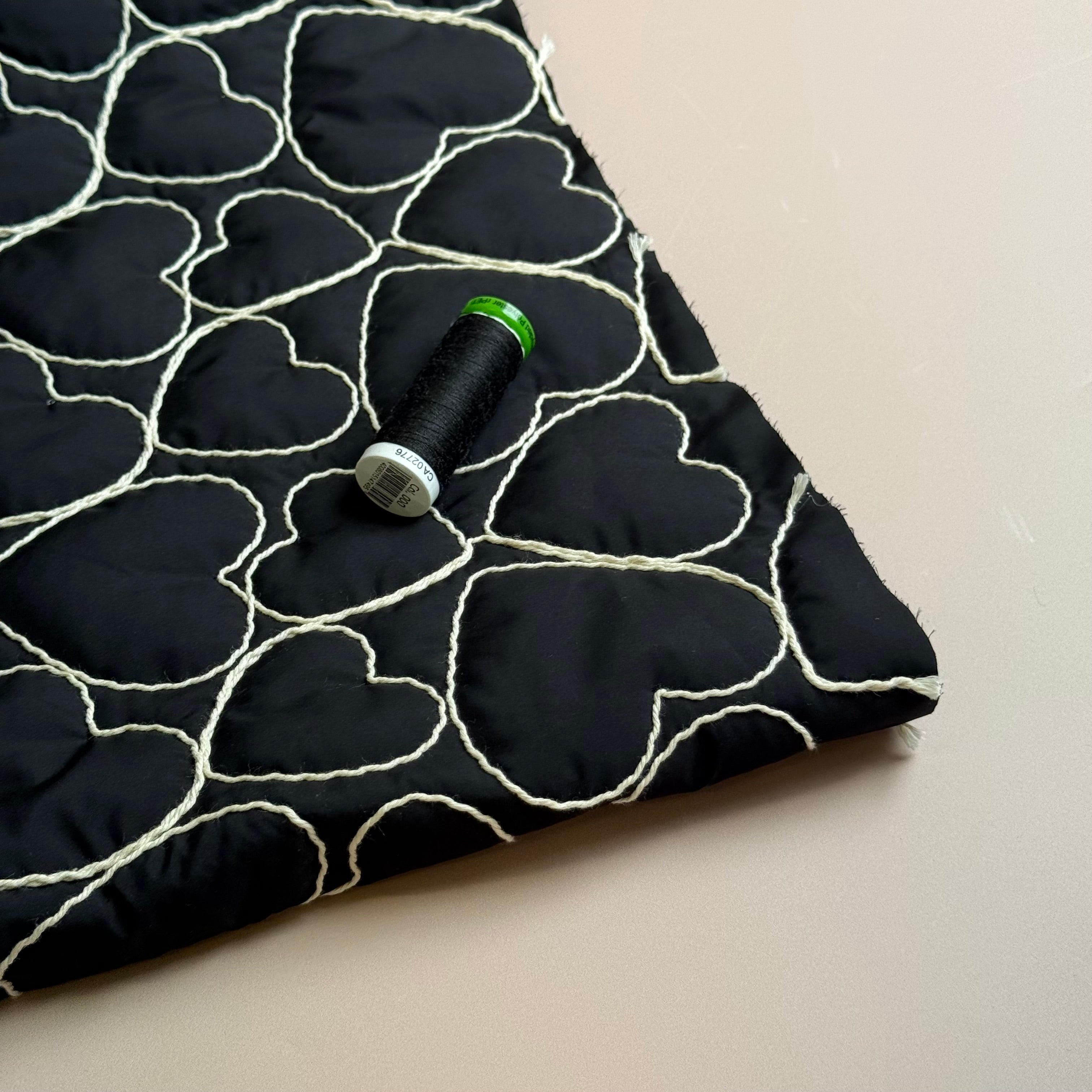 Embroidered Hearts on Black Quilted Fabric