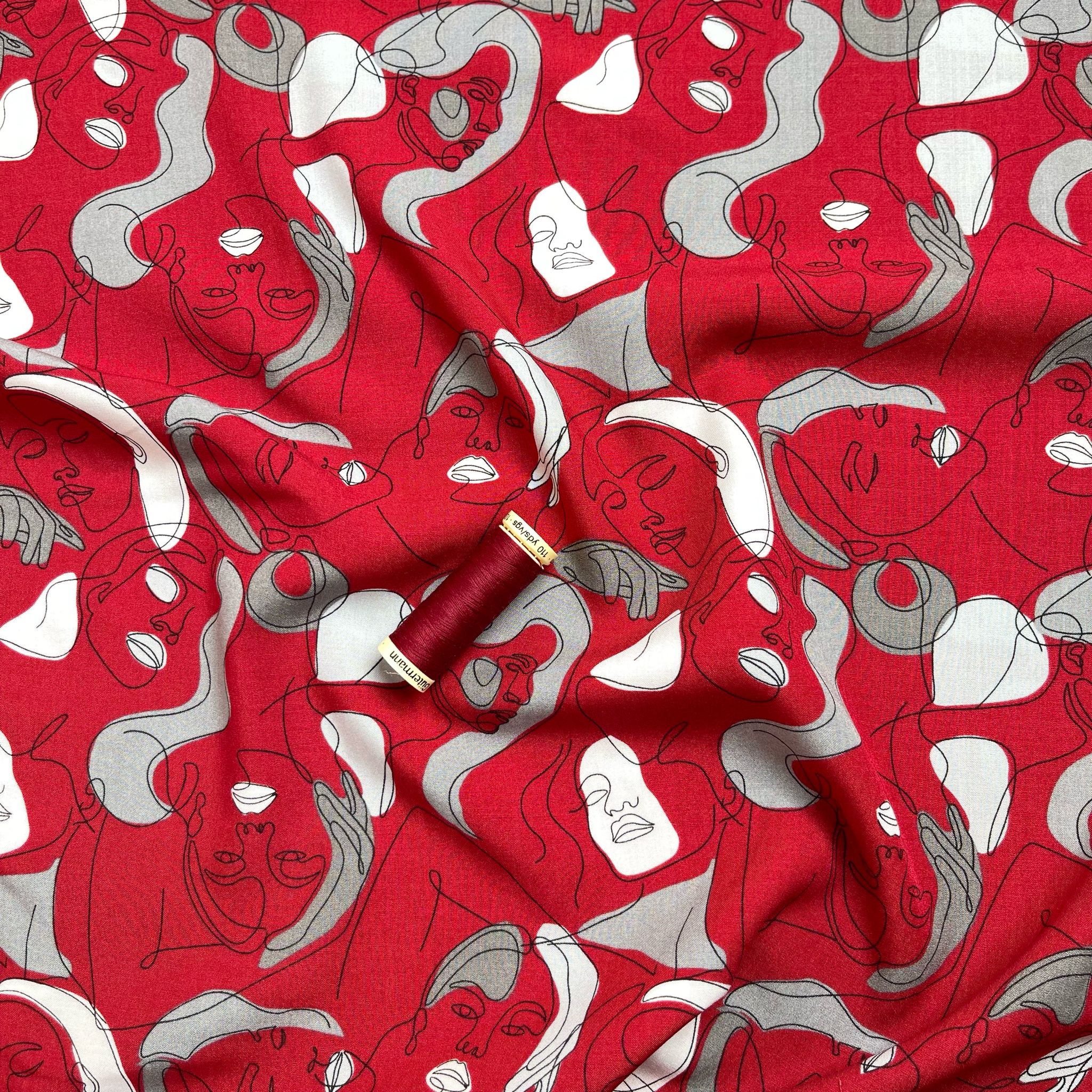 Faces on Red Viscose Fabric