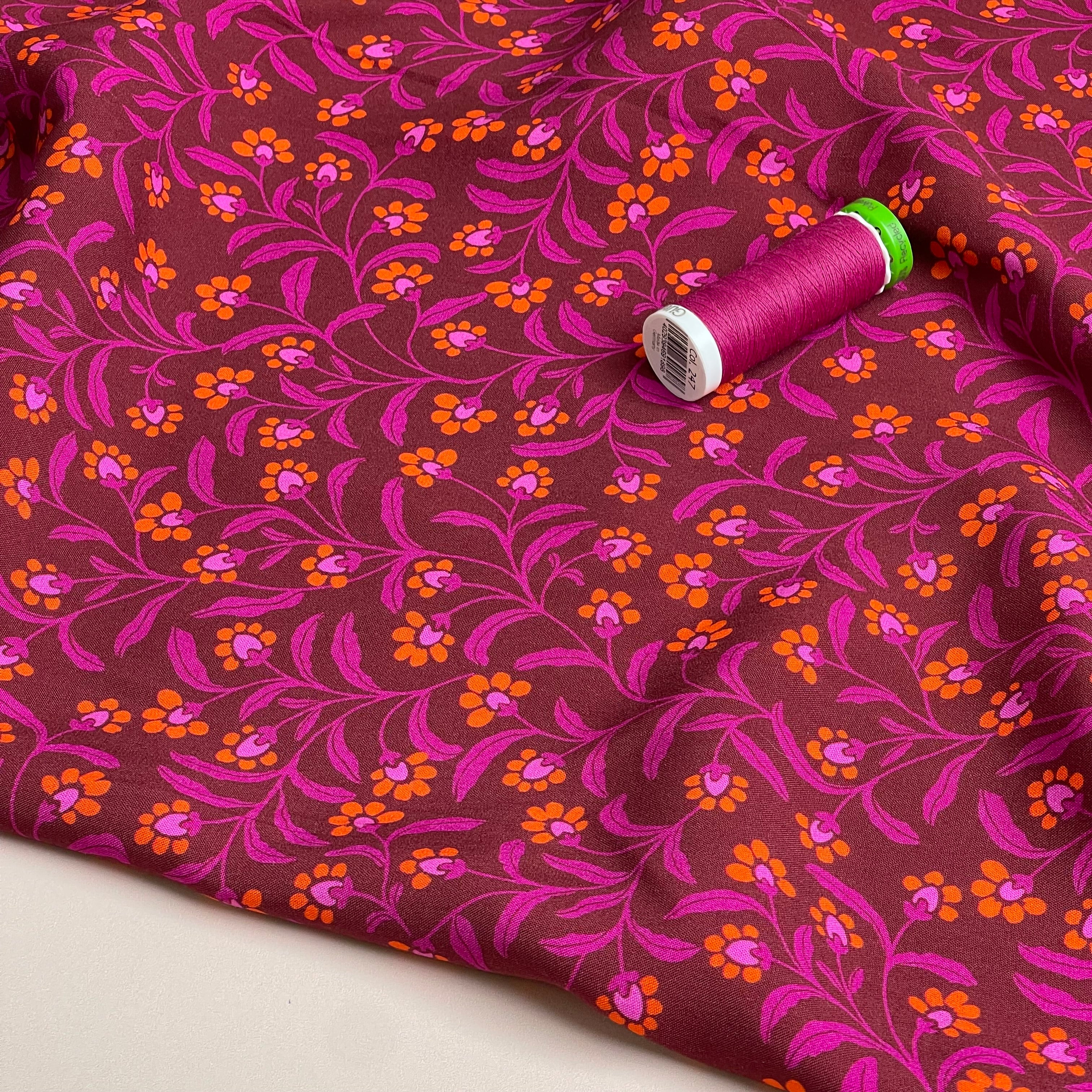 Ditsy Orange Flowers on Burgundy Viscose Fabric
