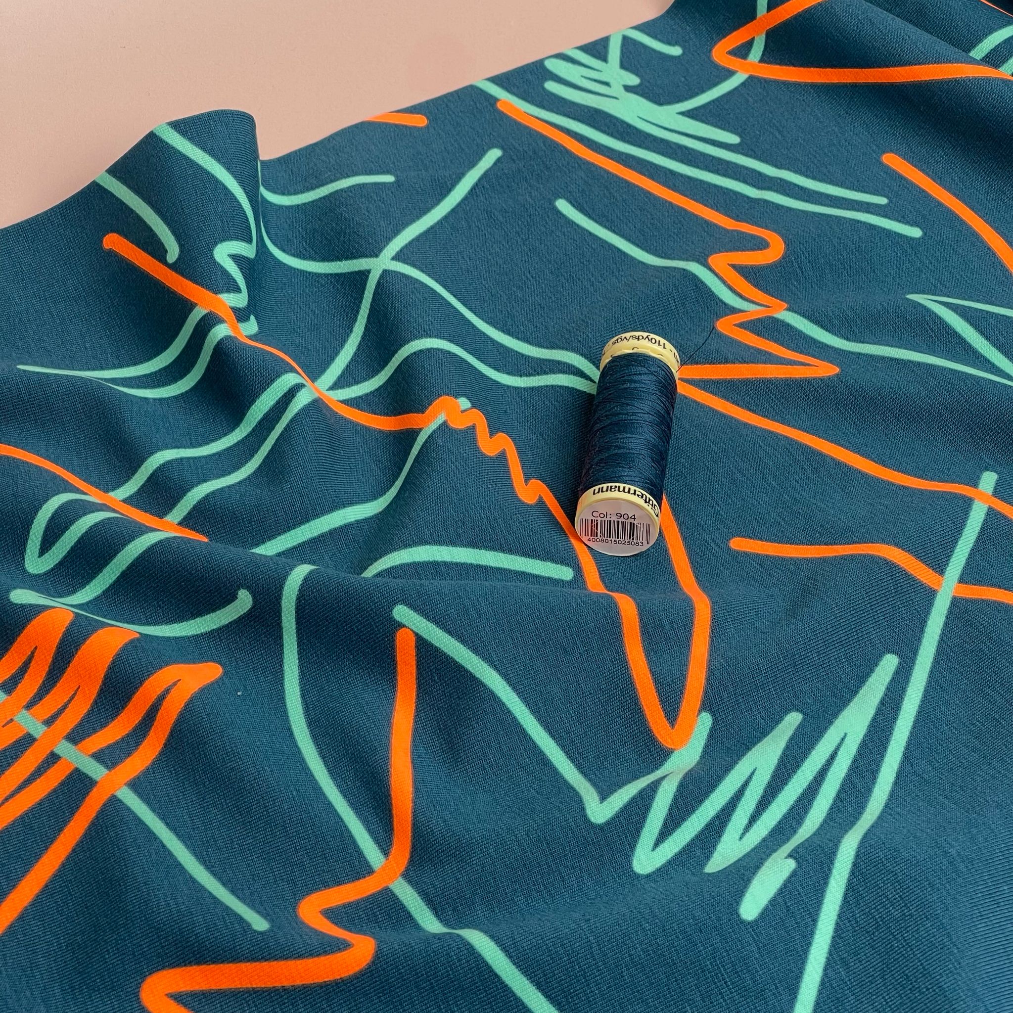 Neon Doodles on Dark Teal Cotton Jersey Fabric