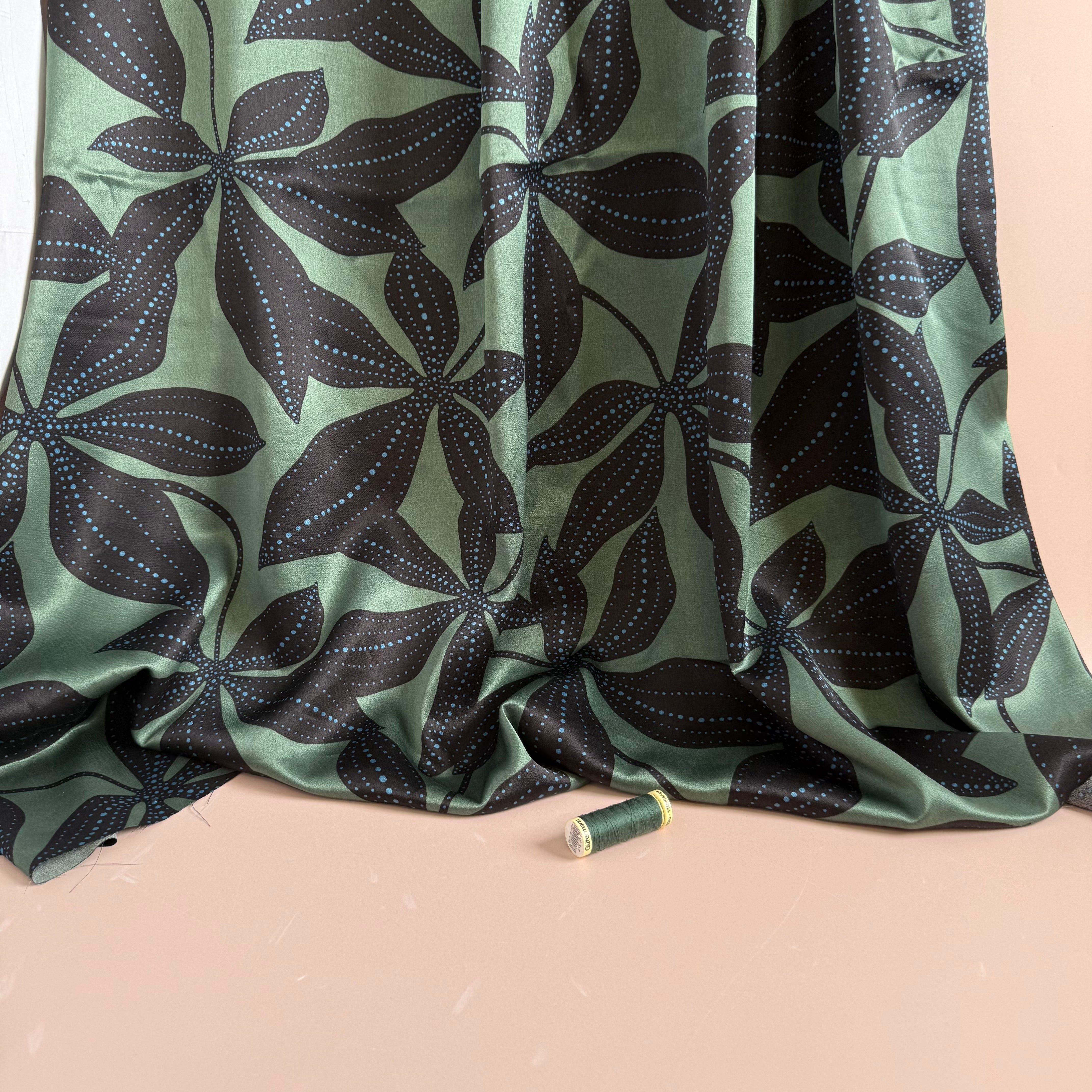 Spotty Flowers on Green Spun Viscose Sateen Fabric