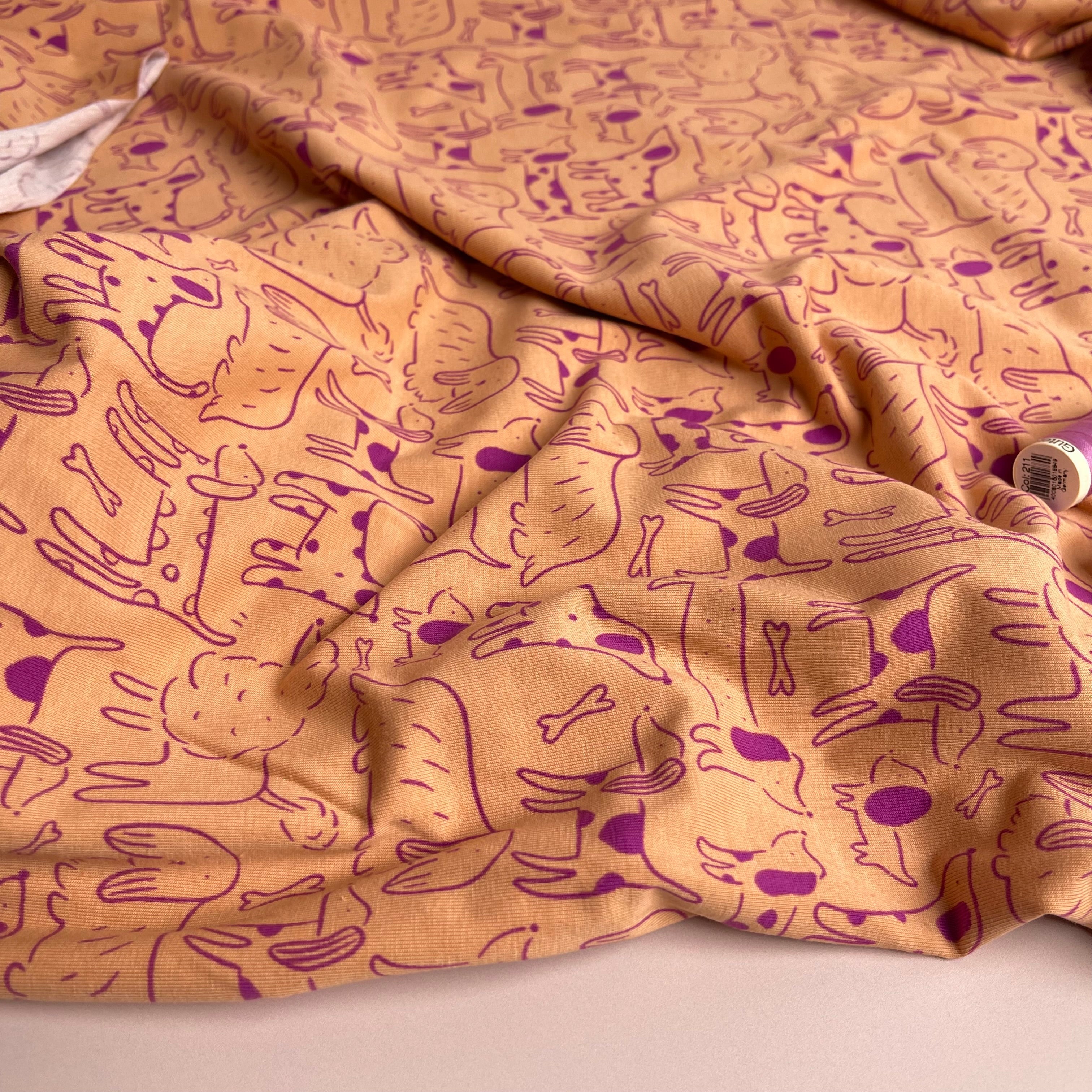 Dog Park on Peach Cotton Jersey Fabric