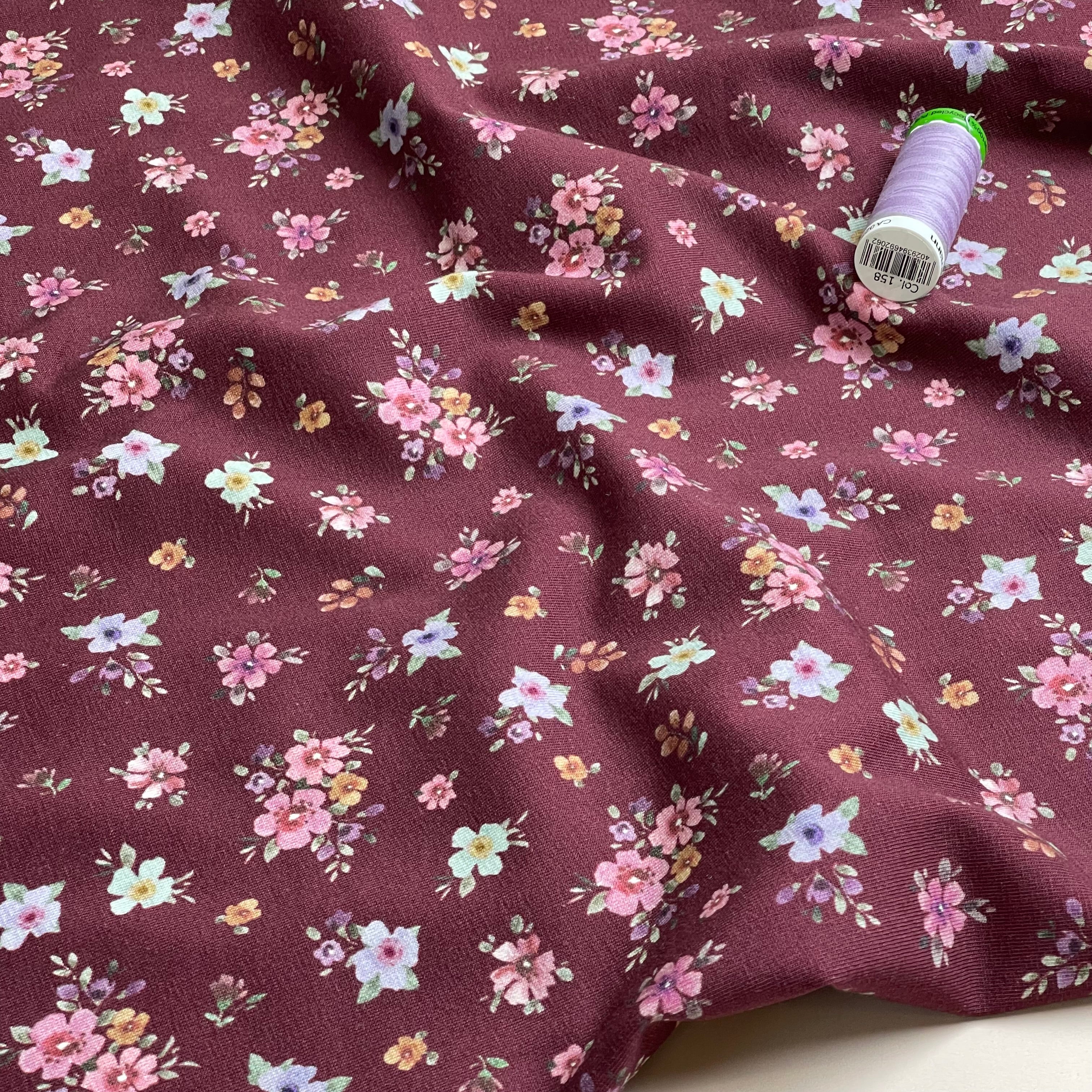 Scattered Autumn Flowers on Burgundy Cotton Jersey Fabric