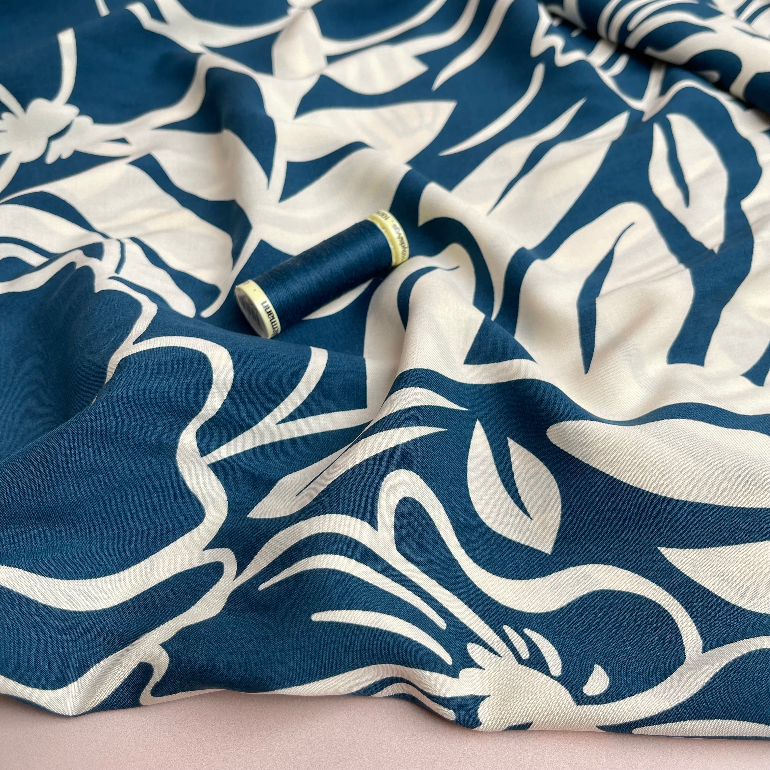 Off-White Blooms on Blue Viscose Fabric