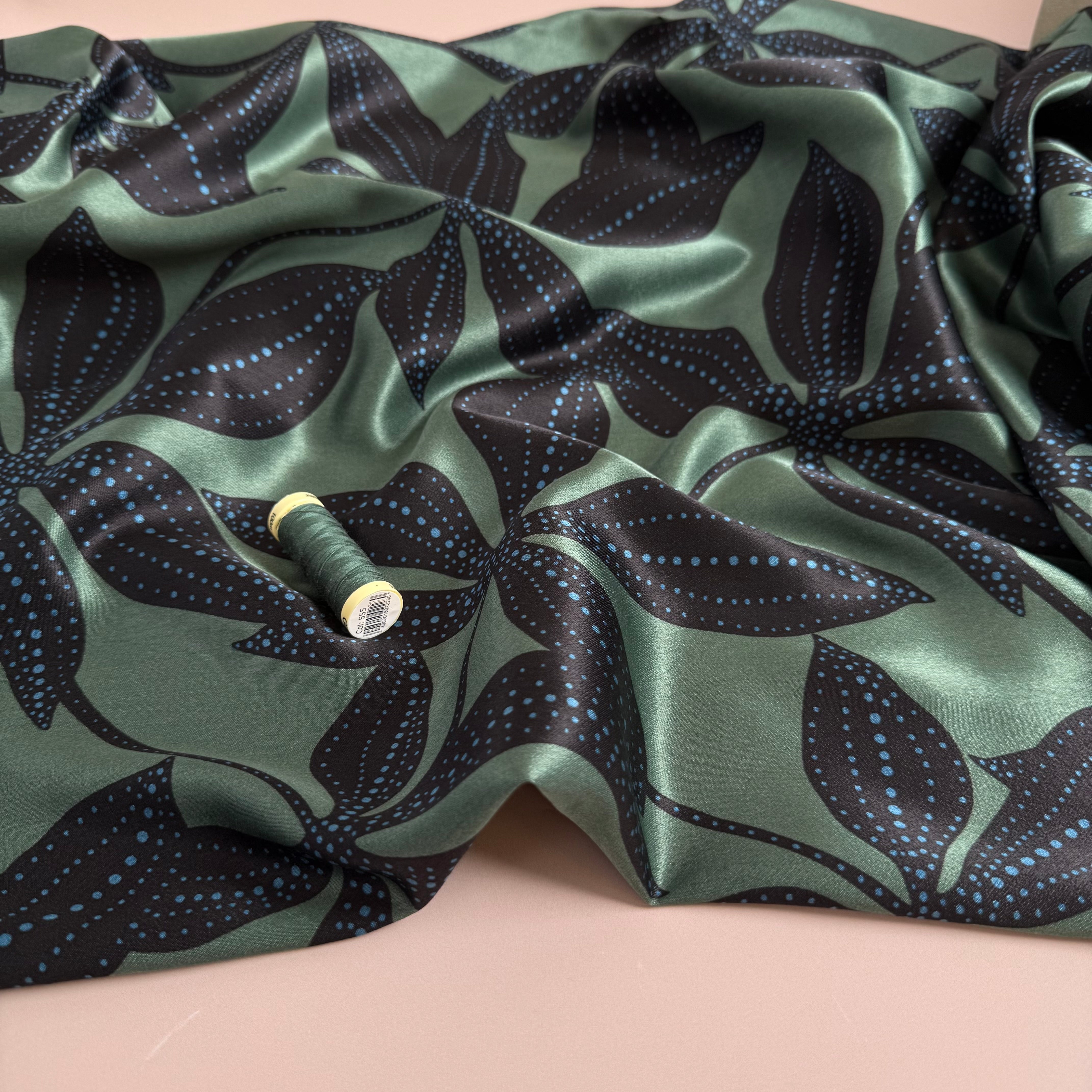 Spotty Flowers on Green Spun Viscose Sateen Fabric