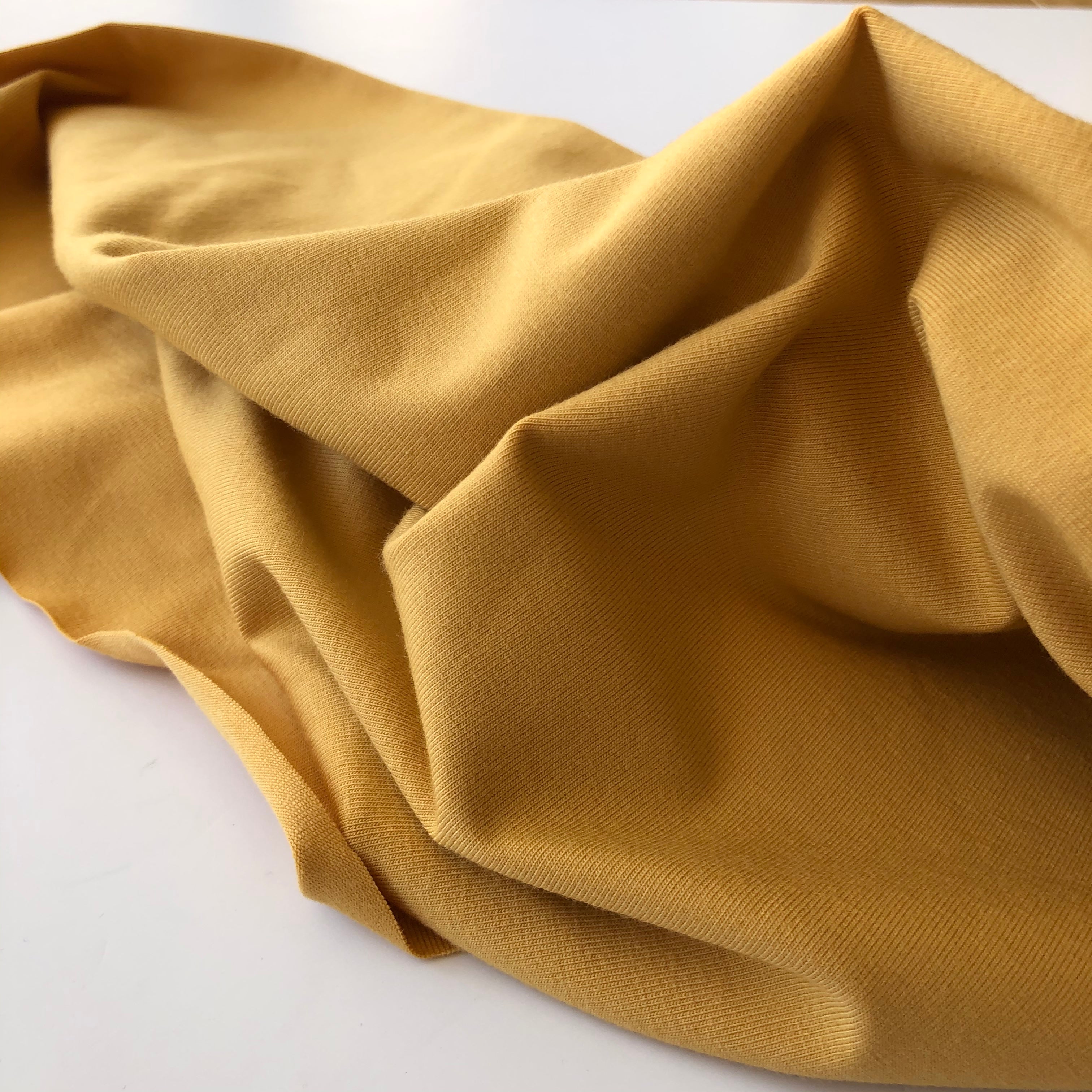 REMNANT 1.00 Metre with washable dirt marks - Essential Chic Amber Plain Cotton Jersey Fabric