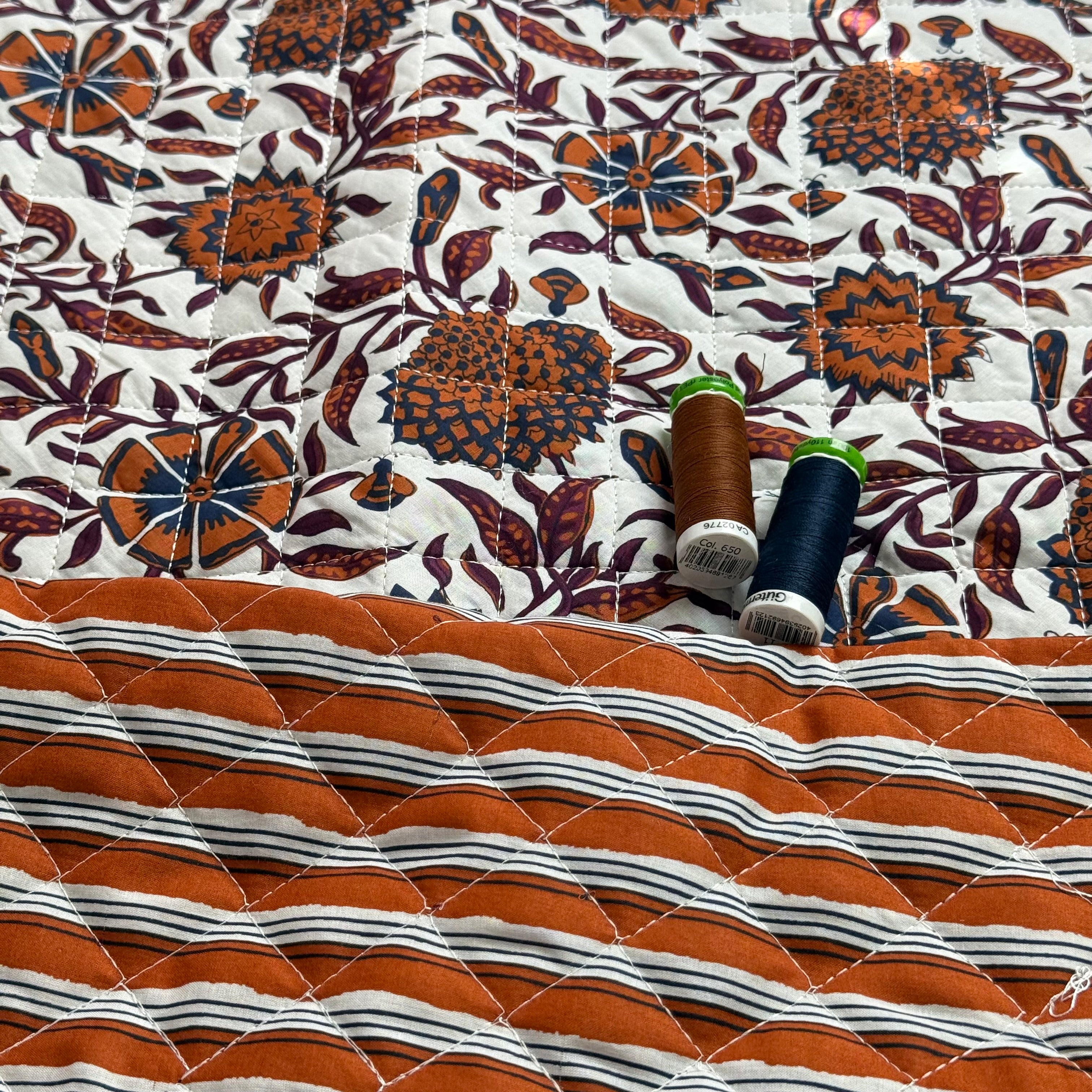 Ornamental Rust Flowers on Off-White Quilted Cotton Fabric