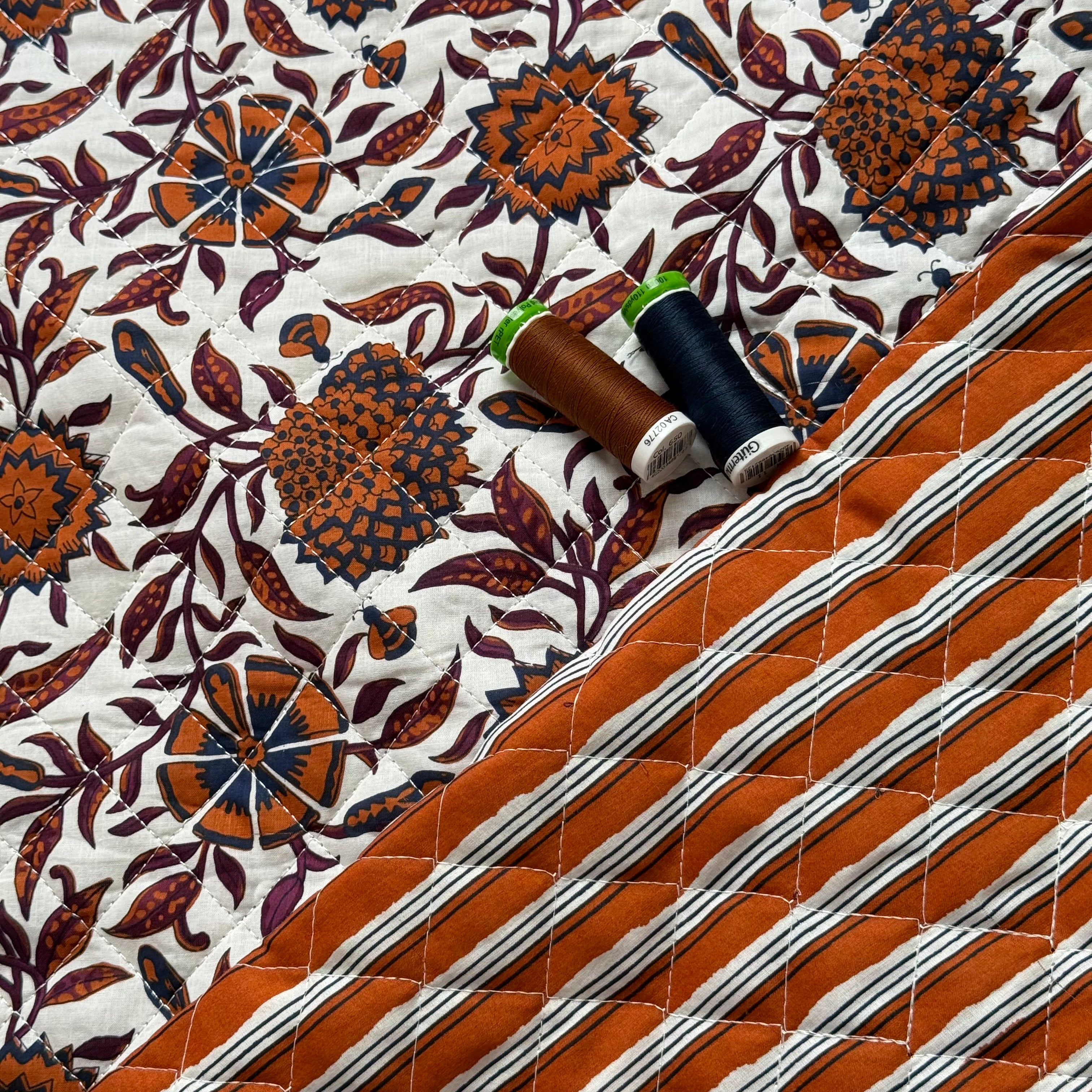 Ornamental Rust Flowers on Off-White Quilted Cotton Fabric
