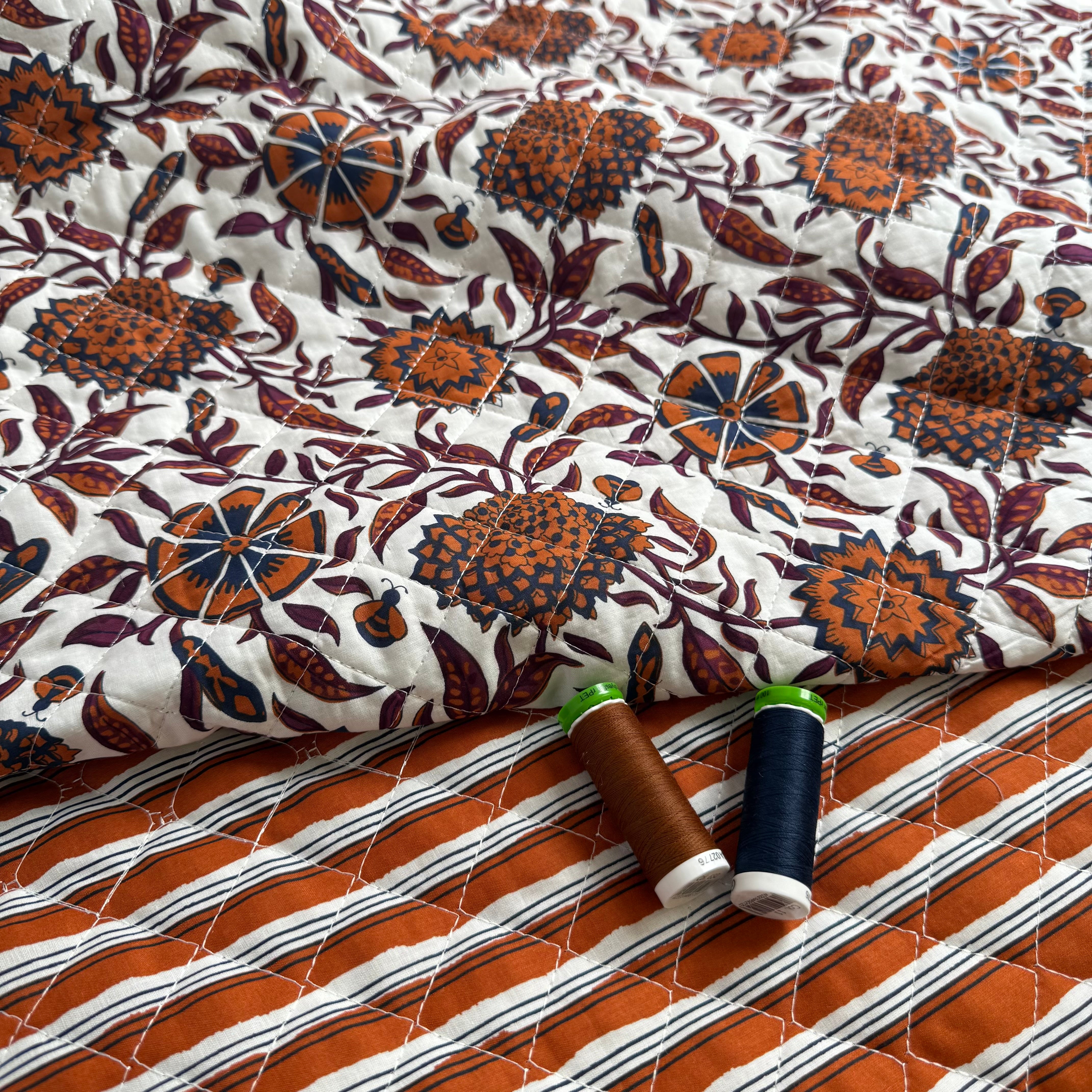 Ornamental Rust Flowers on Off-White Quilted Cotton Fabric
