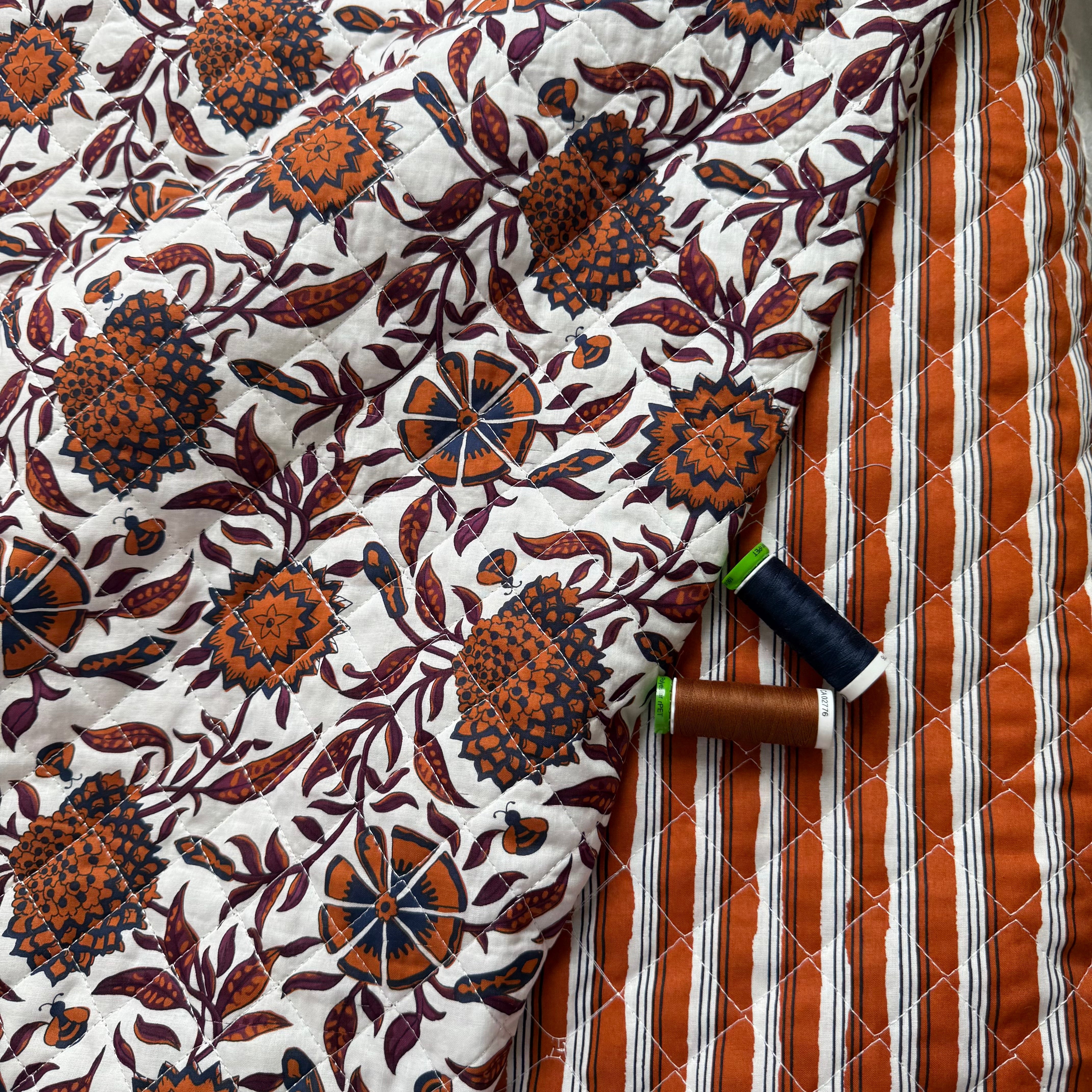 Ornamental Rust Flowers on Off-White Quilted Cotton Fabric