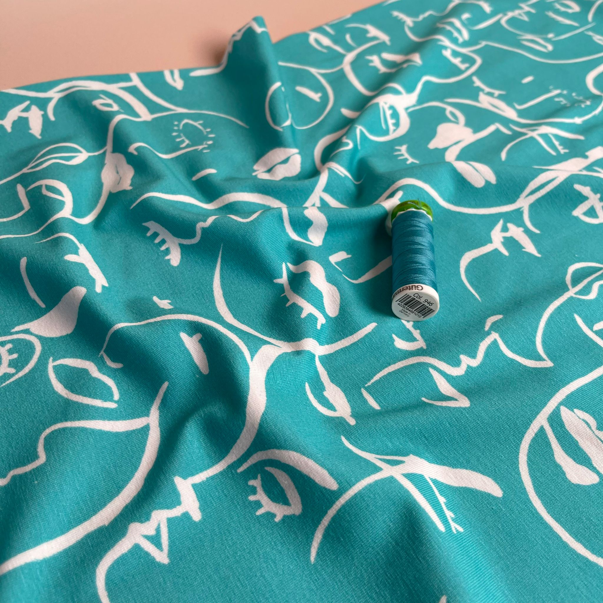 REMNANT 2.33 Metres - Danish Design - Painted Faces on Turquoise Cotton Jersey Fabric