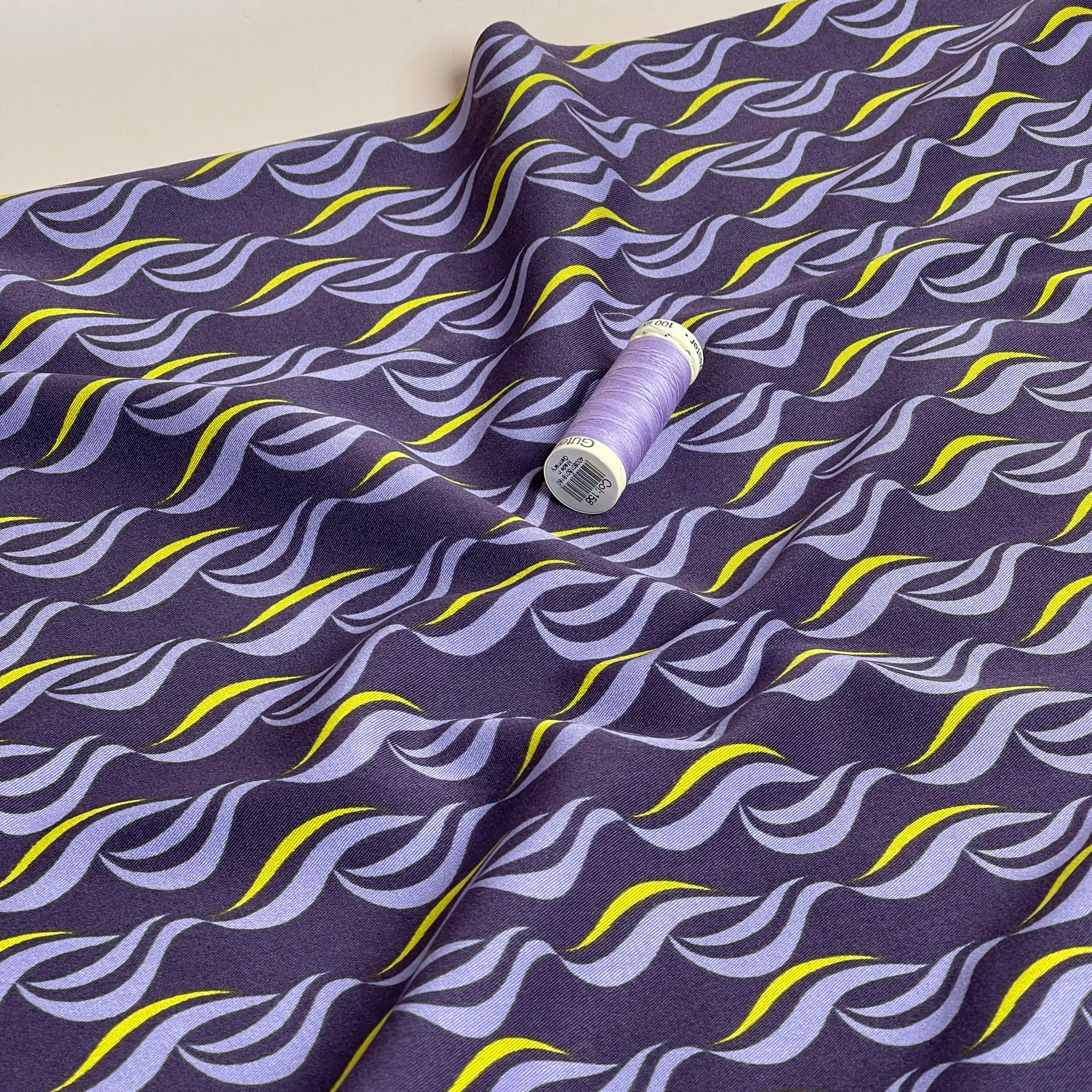 Rosella Waves on Purple Viscose Twill with Stretch