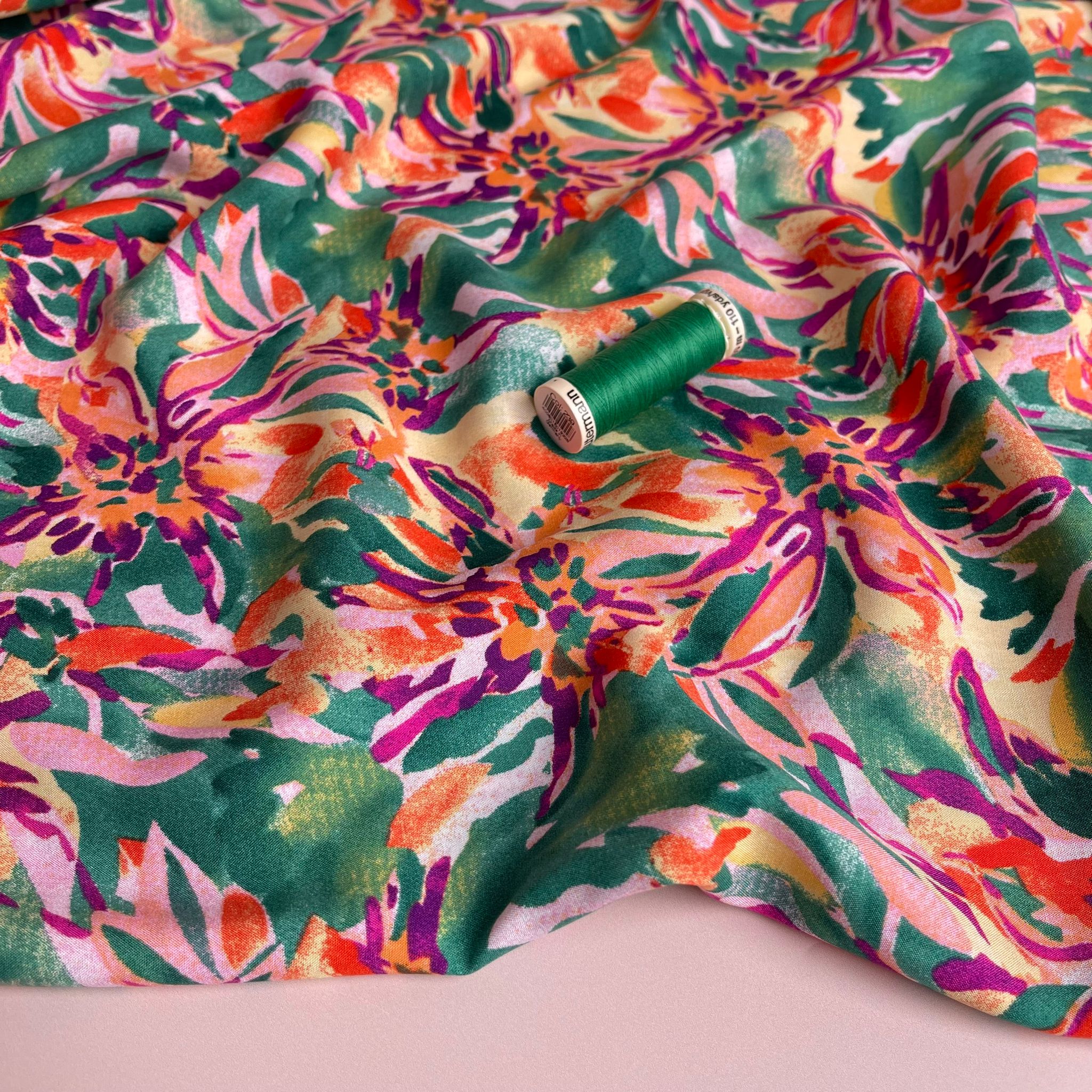 Vibrant Blooms on Green Viscose Fabric